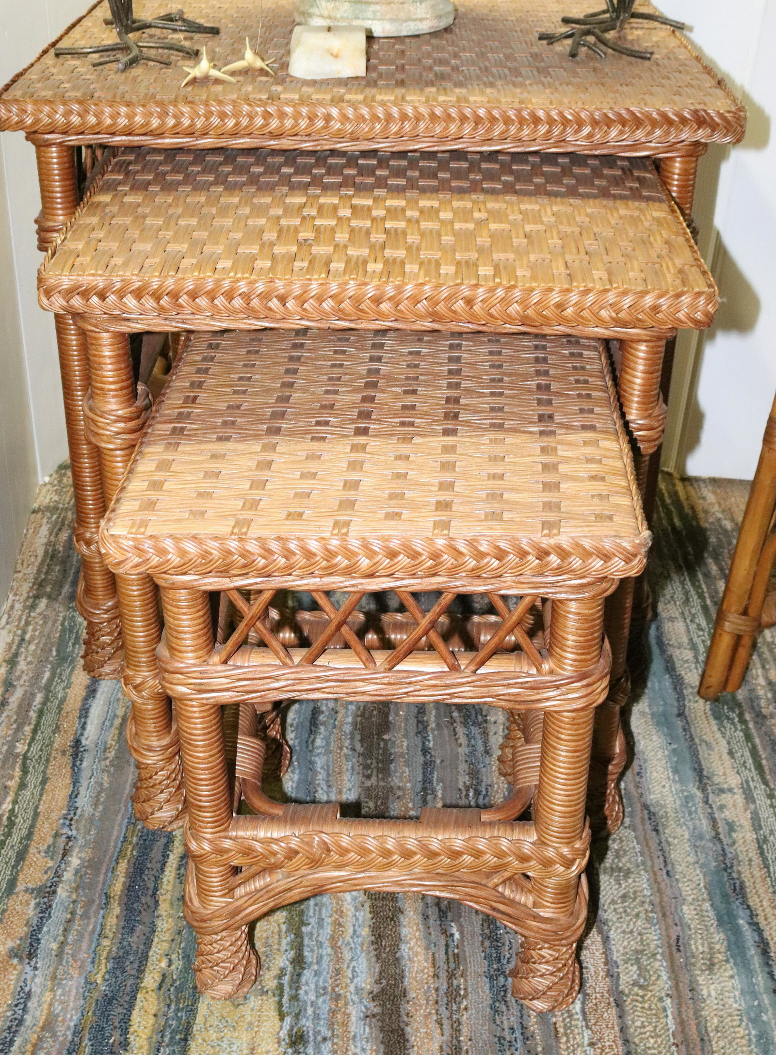 (3) WOVEN NESTED TABLES: WOVEN WICKER STYLE. LARGEST 25 1/2" X 26" X 26" Terms: THIS IS AN ON-SITE ONLINE ONLY AUCTION. THE SALE ADDRESS IS 718 STOKES MILL RD. EAST STROUDSBURG, PA 18302. THIS IS THE ESTATE OF CANDACE BRIGGS.