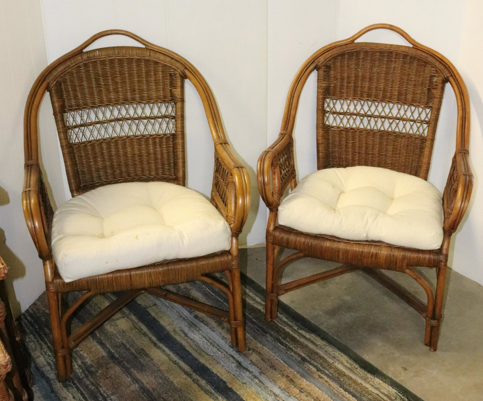 PAIR OF WOVEN ARMCHAIRS: IVORY COLORED SEAT CUSHIONS. MEASURE 36" X 26" X 20". Terms: THIS IS AN ON-SITE ONLINE ONLY AUCTION. THE SALE ADDRESS IS 718 STOKES MILL RD. EAST STROUDSBURG, PA 18302. THIS IS THE ESTATE OF CANDACE B