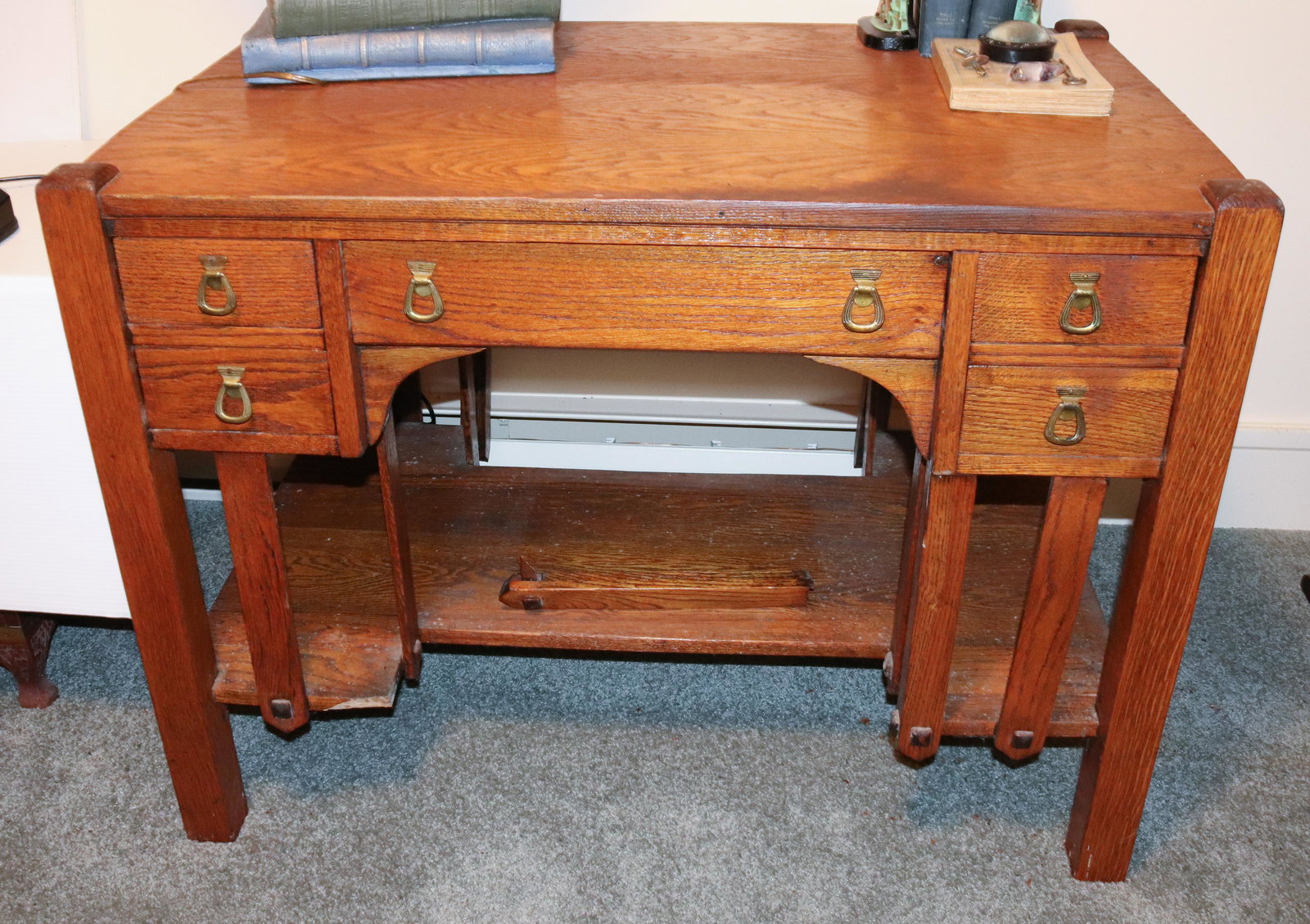 ARTS AND CRAFTS OAK DESK: FIVE DRAWERS WITH BRASS HARDWARE. LOWER SHELF. MEASURES 28" X 38" X 24". Terms: THIS IS AN ON-SITE ONLINE ONLY AUCTION. THE SALE ADDRESS IS 718 STOKES MILL RD. EAST STROUDSBURG, PA 18302. THIS IS THE 