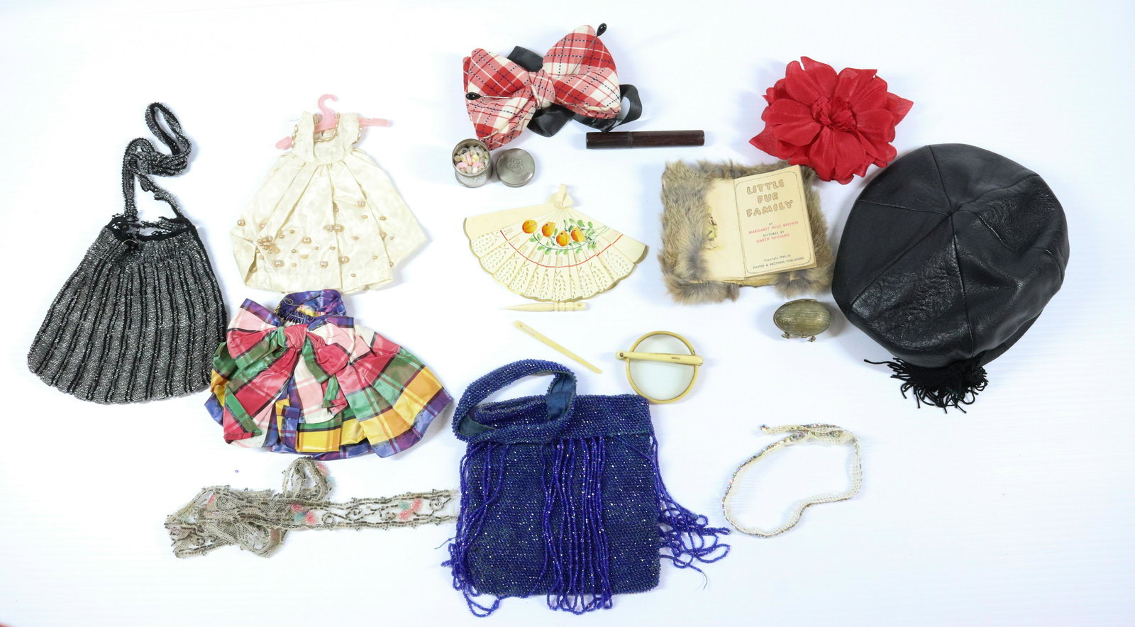MISCELLANEOUS GROUPING: INCLUDES EGG THIMBLE HOLDER BONE NEEDLES WOOD NEEDLE CASE TWO BEADED PURSES WITH DAMAGE BOW TIES LEATHER CAP FURRY FAMILY STORY BOOK ETC HAT 8" DIAMETER Terms: THIS IS AN ON-SITE ONLINE ONLY AUCTION. 