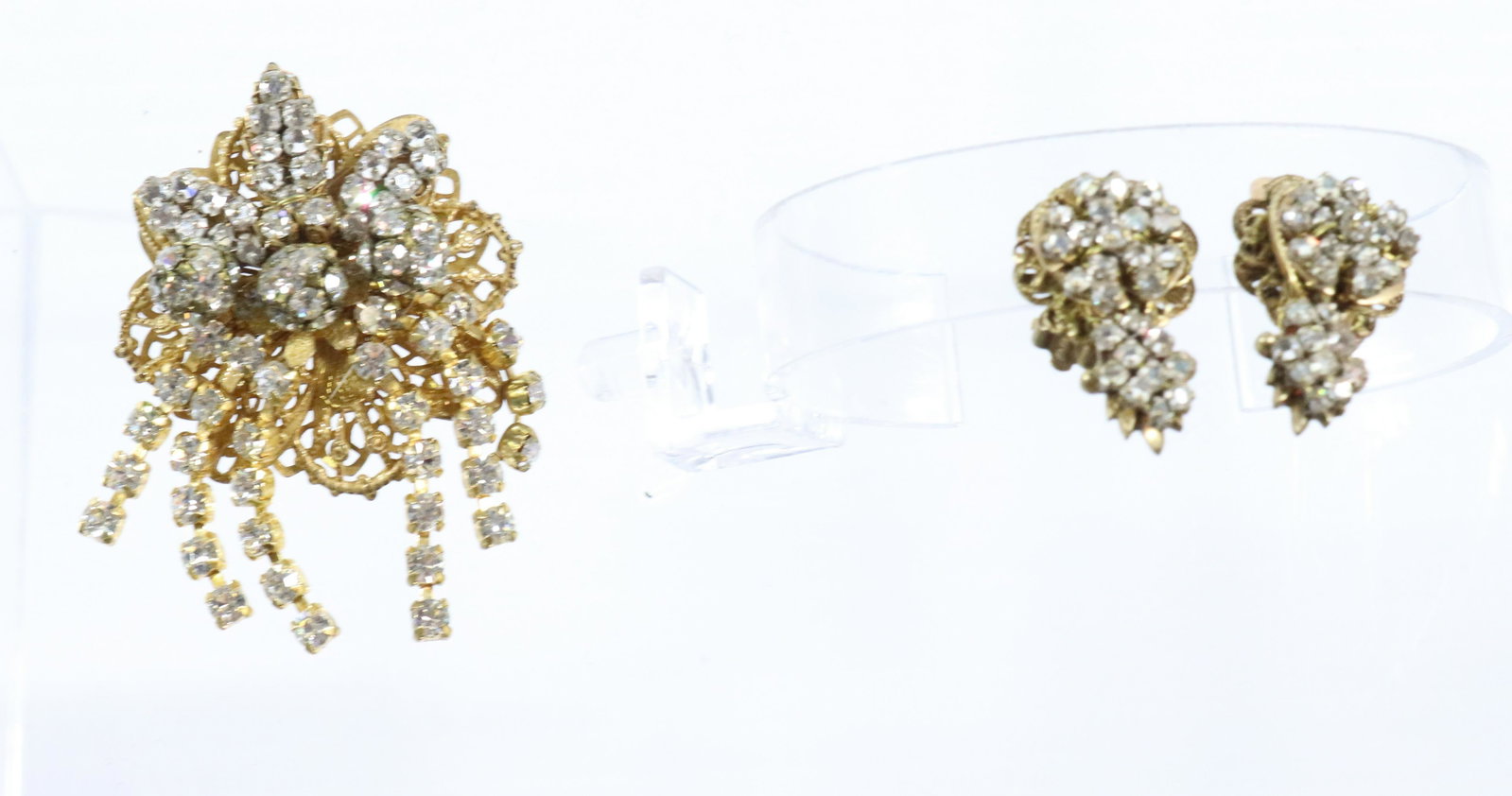 STANLEY HAGLER BROOCH/EARRINGS: BOTH WITH CRYSTALS STANLEY HAGLER TAB ON REVERSE WIRED CONSTRUCTION 2 1/4" X 1 3/4" 1/2" X 1 1/4" Terms: THIS IS AN ON-SITE ONLINE ONLY AUCTION. THE SALE ADDRESS IS 718 STOKES MILL RD. EAST STROUDSBUR