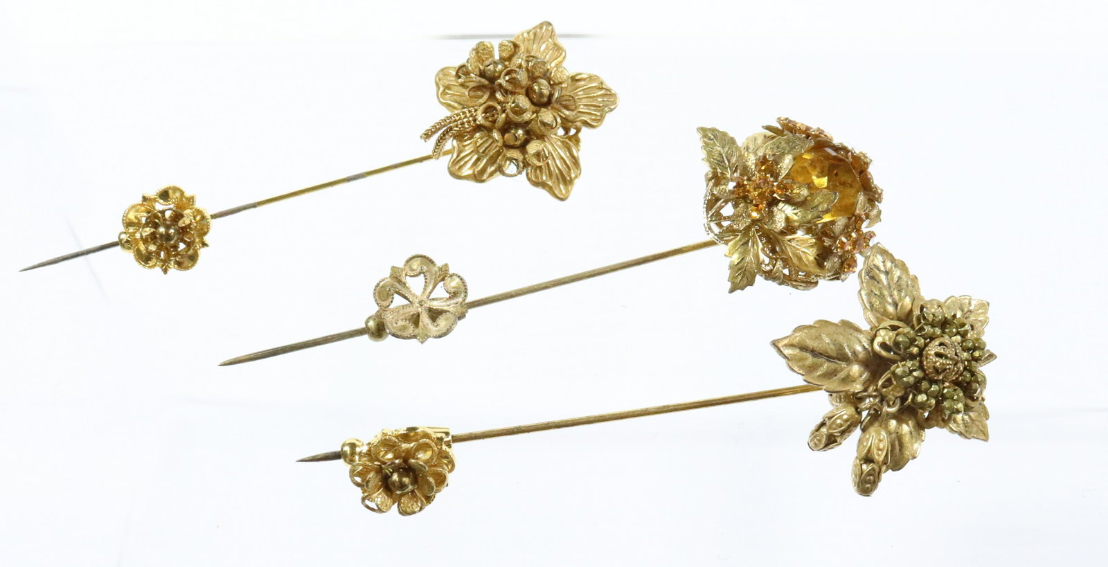 STANLEY HAGLER STICK PINS: (3) GOLD GOLD AND CRYSTALS GOLD AND AMBER CRYSTALS ALL WITH ORNATE CLAMP 1" X 3 1/4" UNMARKED Terms: THIS IS AN ON-SITE ONLINE ONLY AUCTION. THE SALE ADDRESS IS 718 STOKES MILL RD. EAST STROUDSBURG, P
