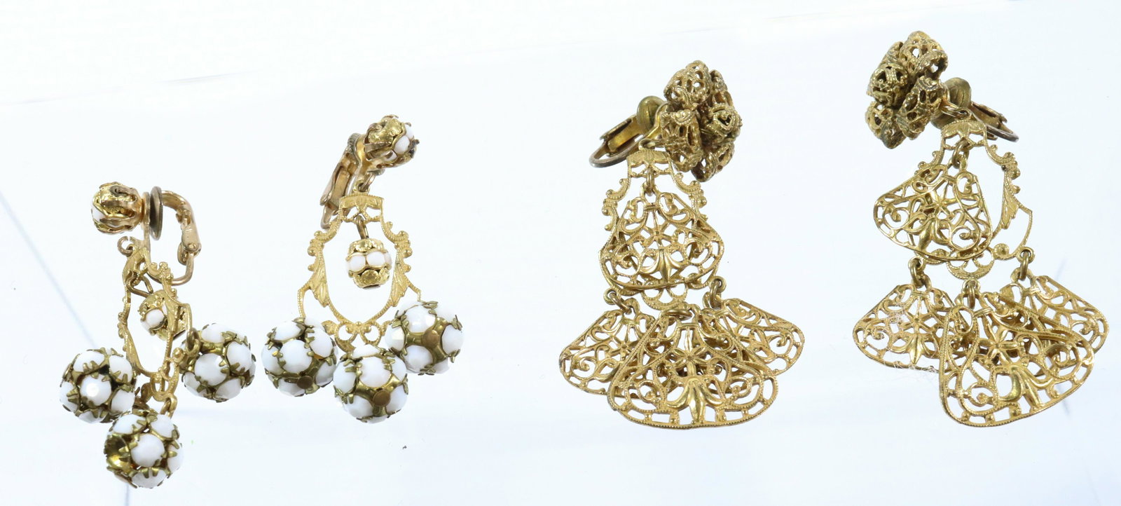 STANLEY HAGLER EARRINGS: (2) PAIR WHITE RHINESTONES AND DROPS WITH TRIANGULAR DISCS 2"L 2 1/2"L UNMARKED Terms: THIS IS AN ON-SITE ONLINE ONLY AUCTION. THE SALE ADDRESS IS 718 STOKES MILL RD. EAST STROUDSBURG, PA 18302. THIS 