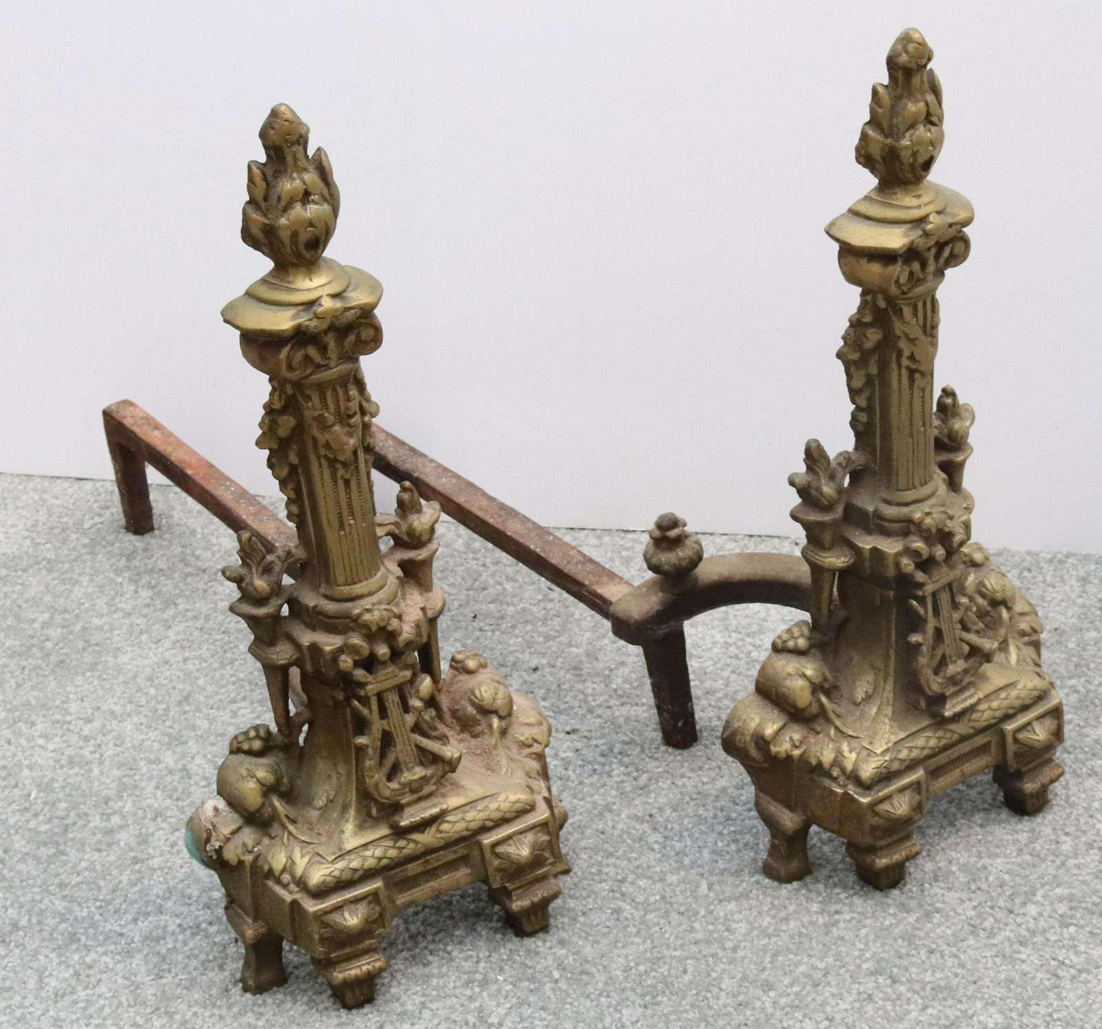 PAIR OF BRASS ANDIRONS: ORNATE ANDIRONS WITH COLUMN AND TORCHES. MEASURE 17 1/2" X 8" X 18 1/2" D. Terms: THIS IS AN ON-SITE ONLINE ONLY AUCTION. THE SALE ADDRESS IS 718 STOKES MILL RD. EAST STROUDSBURG, PA 18302. THIS IS TH