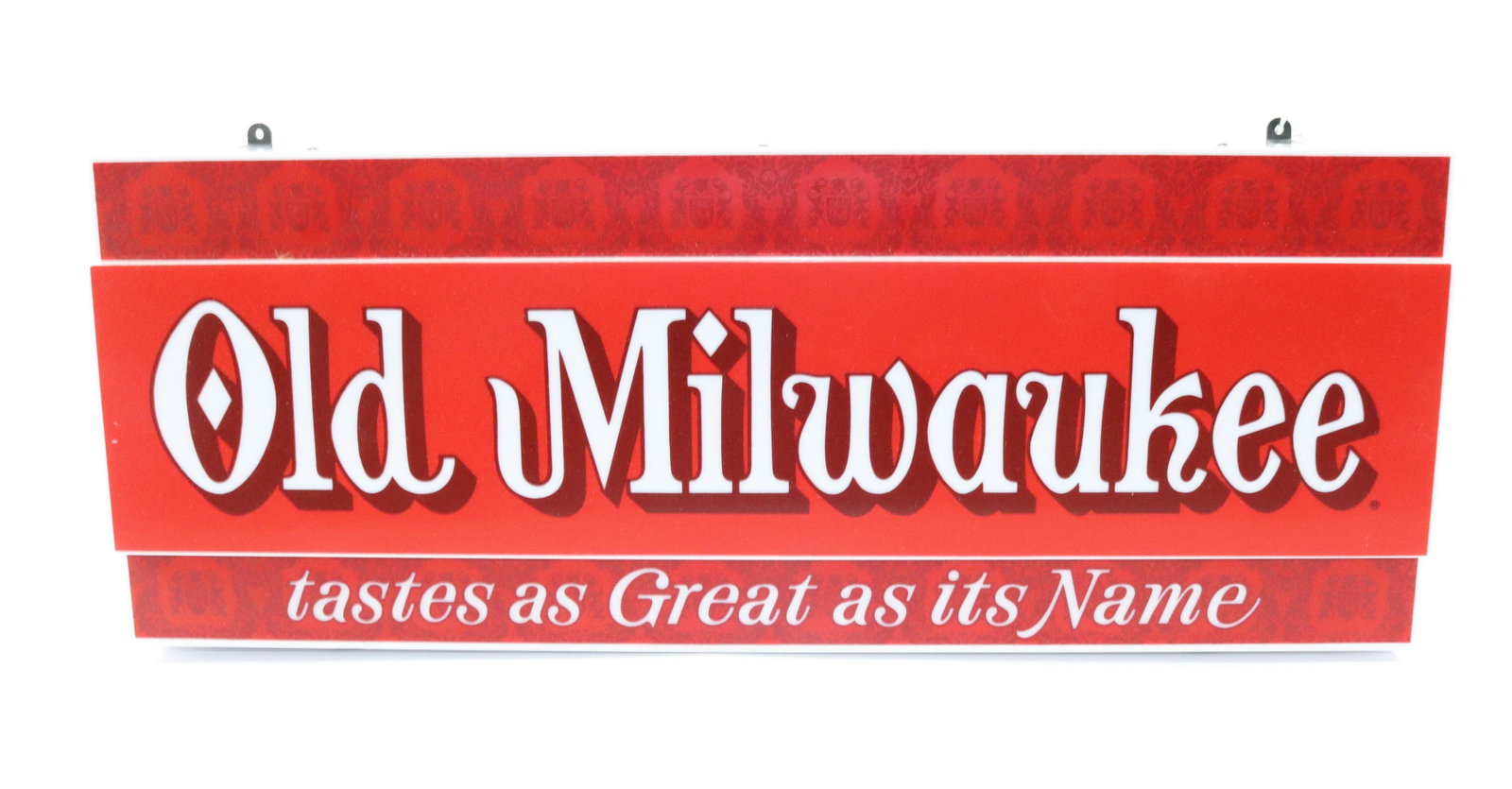 OLD MILWAUKEE LIGHT-UP ADVERTISING SIGN: MOLDED PLASTIC "TASTES AS GREAT AS ITS NAME". MEASURES 22" X 8 1/2".