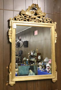 ITALIAN GOLD LEAF MIRROR: CARVED WOOD WITH MARRIAGE DOVES AT SCEPTER AND ARROW QUIVER. GOLD OVER RED WITH DISTRESSED FINISH. MRKD. ON BACK "IMPORTED FROM ITALY FROM KINDEL FURNITURE CO. GRAND RAPIDS, MI". 49"H X 31" Terms: