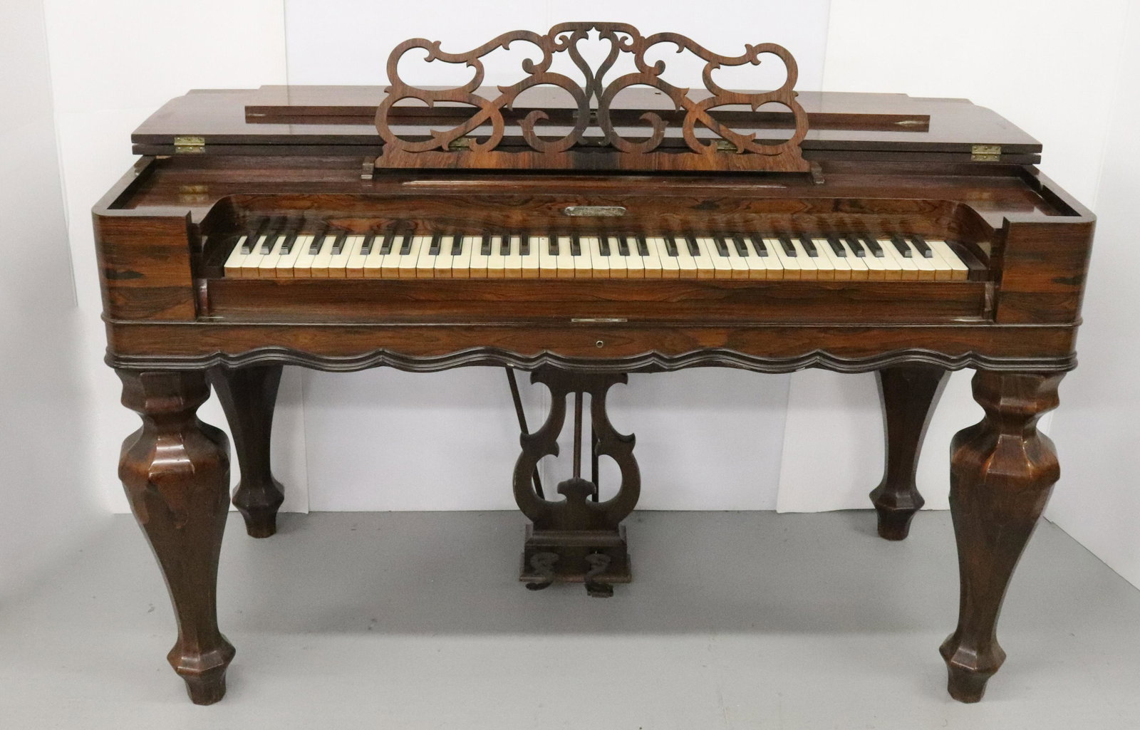 TREAT, LINSLEY & CO. MELODEON: 1867 NEW HAVEN,CT. ROSEWOOD VENEER WITH FRENCH POLISH FINISH MUSIC RACK AND LYRE PEDAL BASE.. 32"H X 53" X 26" Terms: Please read Carefully before bidding. This is a Two-Part Estate Sale. Pick-up for 