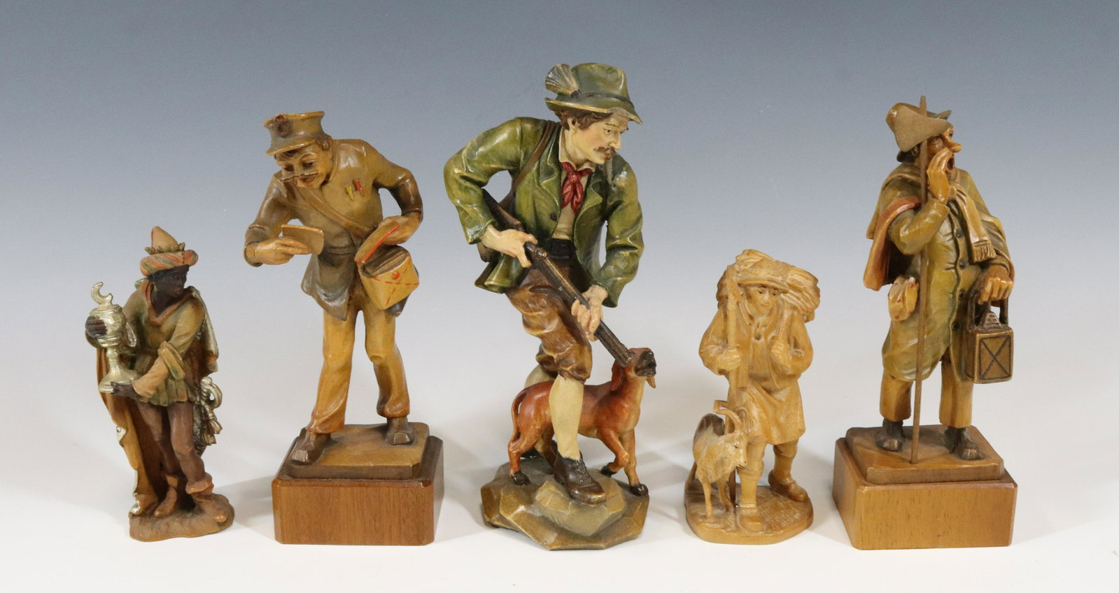 (5) CARVED WOOD FIGURINES: HIKER HUNTER MAIL MAN BLACKAMOOR TOWN CRIER 5 TO 7 1/2" Terms: Please read Carefully before bidding. This is a Two-Part Estate Sale. Pick-up for these sales will be Tuesday November 8th through Friday