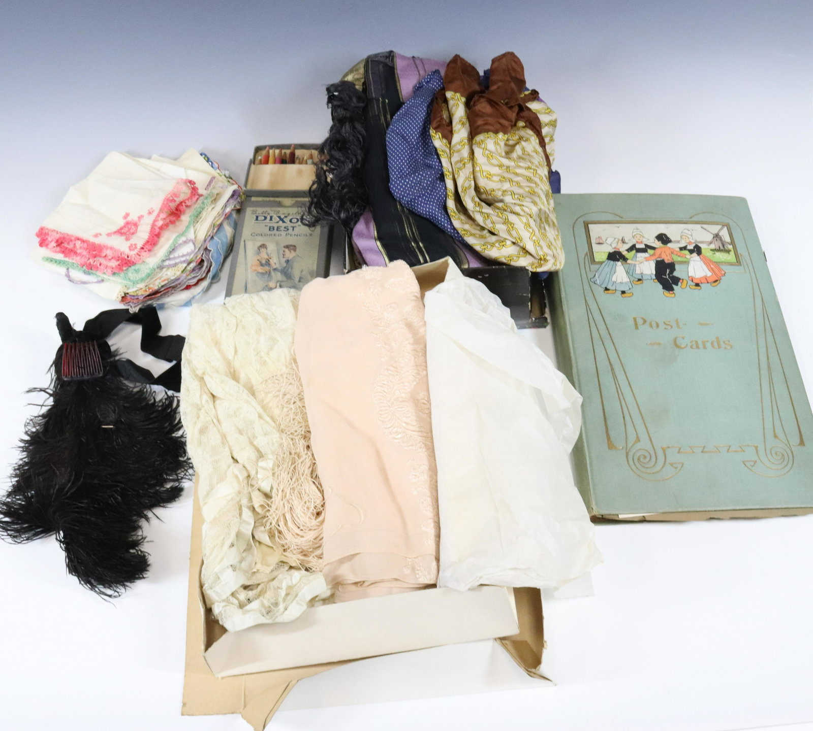 POSTCARDS SILK SCARVES AND HANDKERCHIEF GROUP: POSTCARD ALBUM, BOX OF SCARVES AND STACK OF HANDKERCHIEF 15" X 11" Terms: Please read Carefully before bidding. This is a Two-Part Estate Sale. Pick-up for these sales will be Tuesday November 8th thr