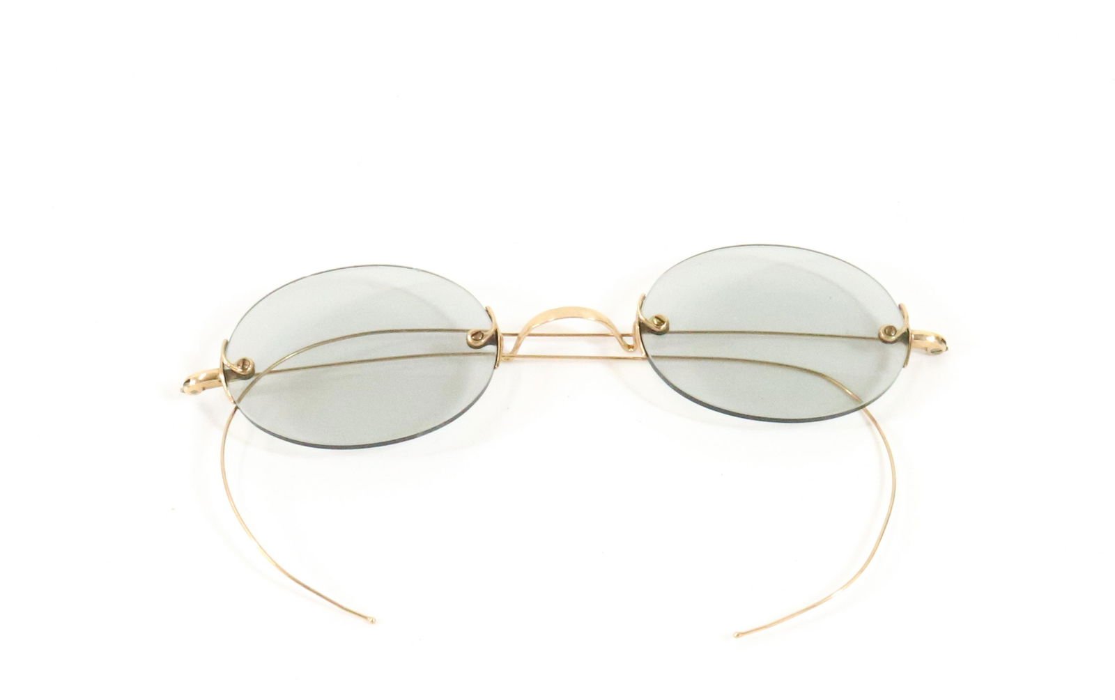10K YELLOW GOLD EYEGLASSES: WITH TINTED LENS OVAL SHAPE 4 1/2" X 4" 7.5 DWT TOTAL WEIGHT Terms: Please read Carefully before bidding. This is a Two-Part Estate Sale. Pick-up for these sales will be Tuesday November 8th through F