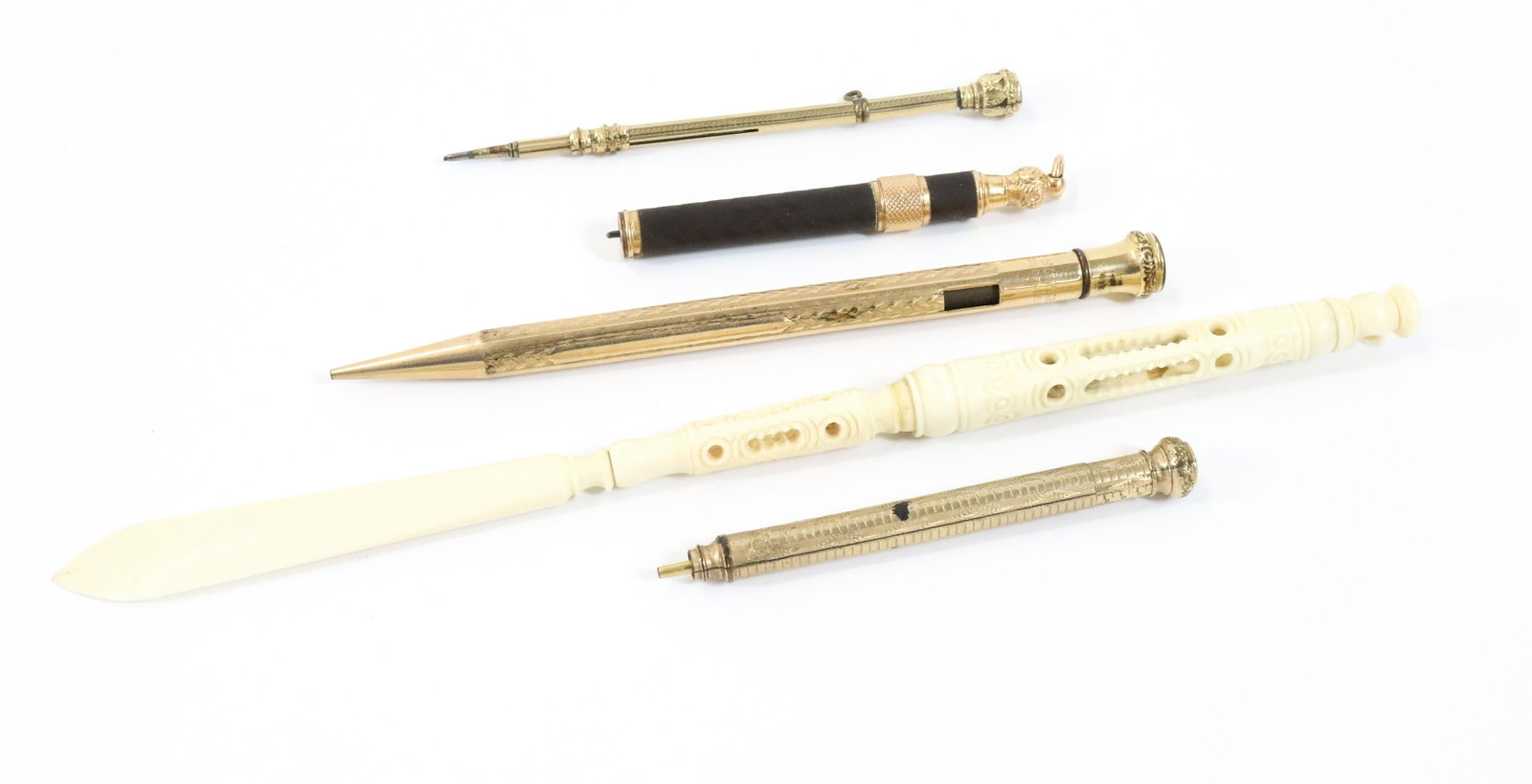 GOLD PLATE LEAD PENCILS: (5) BONE CARVED LETTER OPENER, FOUR GOLD FILLED LEAD PENCILS ONE WITH JEWEL, 3" TO 8 1/23" Terms: Please read Carefully before bidding. This is a Two-Part Estate Sale. Pick-up for these sales will be 