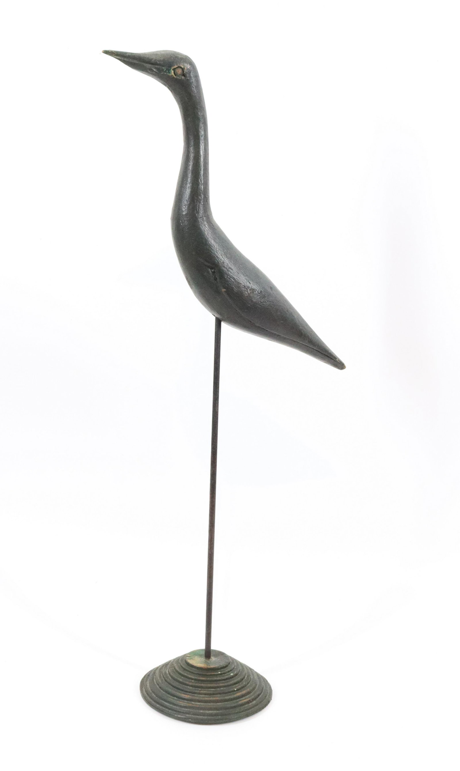 CARVED FOLK ART BIRD: CARVED BIRD IN DARK GREEN PAINT, ON METAL ROD IN TURNED WOODEN BASE - 19 1/4" H Please Read Carefully before Bidding. Hartzell’s Auction Gallery Inc. will Conduct an ON-SITE and also ON-LINE Auc