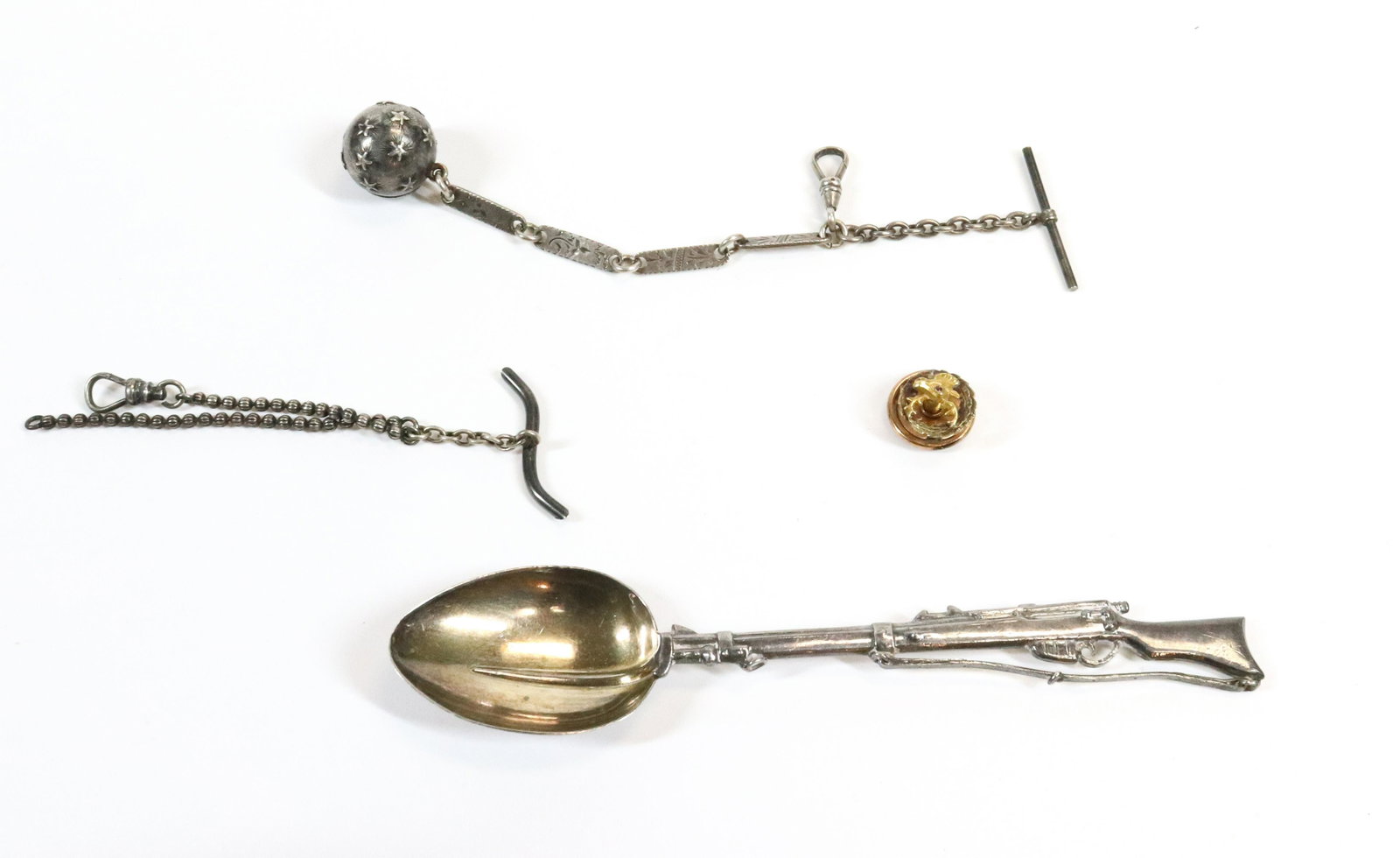 SILVER AND GOLD GROUPING: SILVER HAND WROUGHT RIFLE SPOON WW1 ERA WITH BAYONET TWO COIN SILVER WATCH CHAINS ONE WITH MOON AND STAR ROUND CHARM AND 10K MOOSE LODGE PIN SPOON 5", 5" CHAINS 1.26 OZ TOTAL WEIGHT UPDATED 2023 Terms