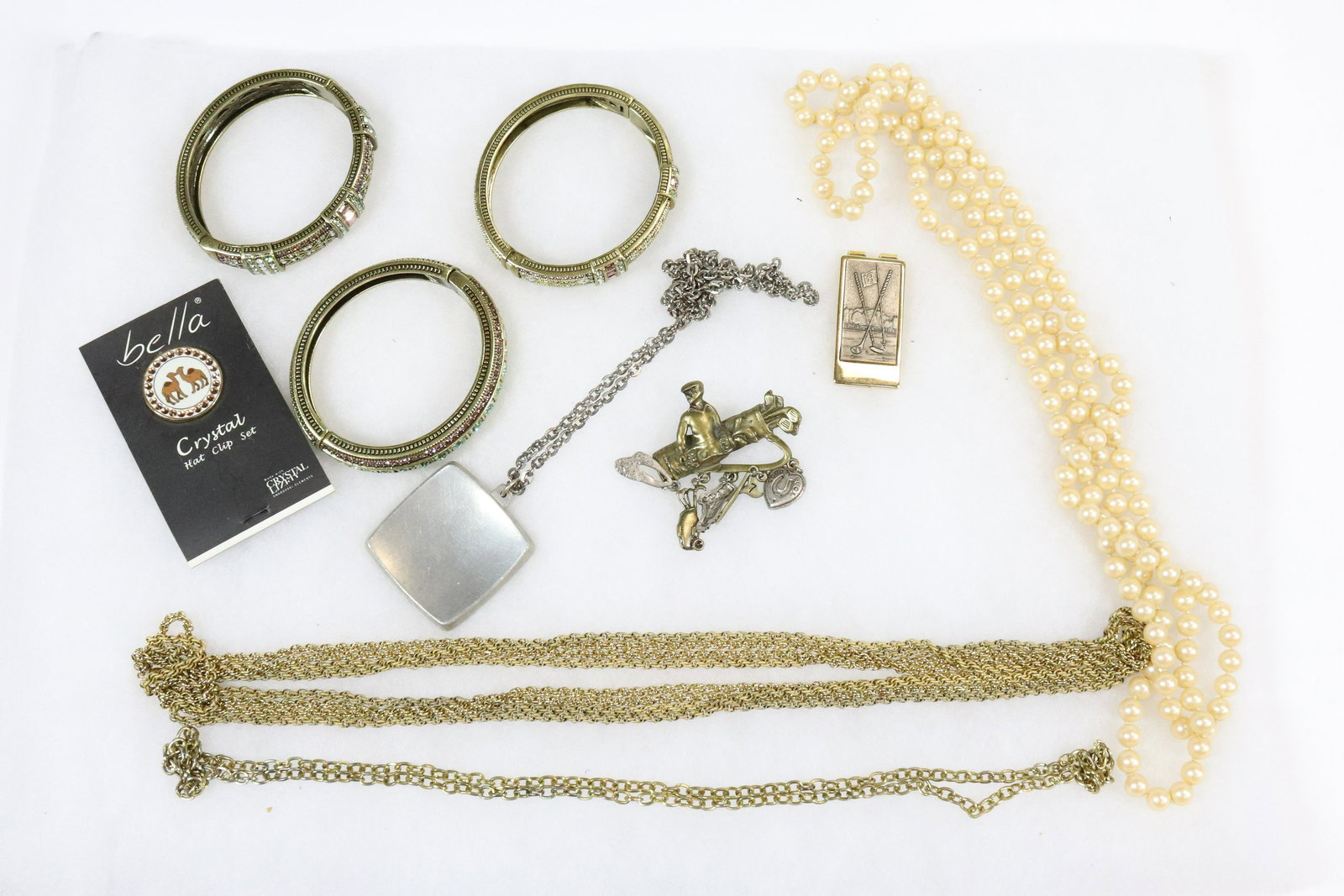 JEWELED COSTUME JEWELRY BANGLES GROUPING: LIGHT GREEN AND LAVENDER RHINESTONES ALL THREE BANGLES, FAUX PEARLS, 60" GOLD COLOR CHAIN GOLF MONEY CLIP ETC. UPDATED 2023 Terms for Purchasing and Shipping of Auction Items. Please read carefully be