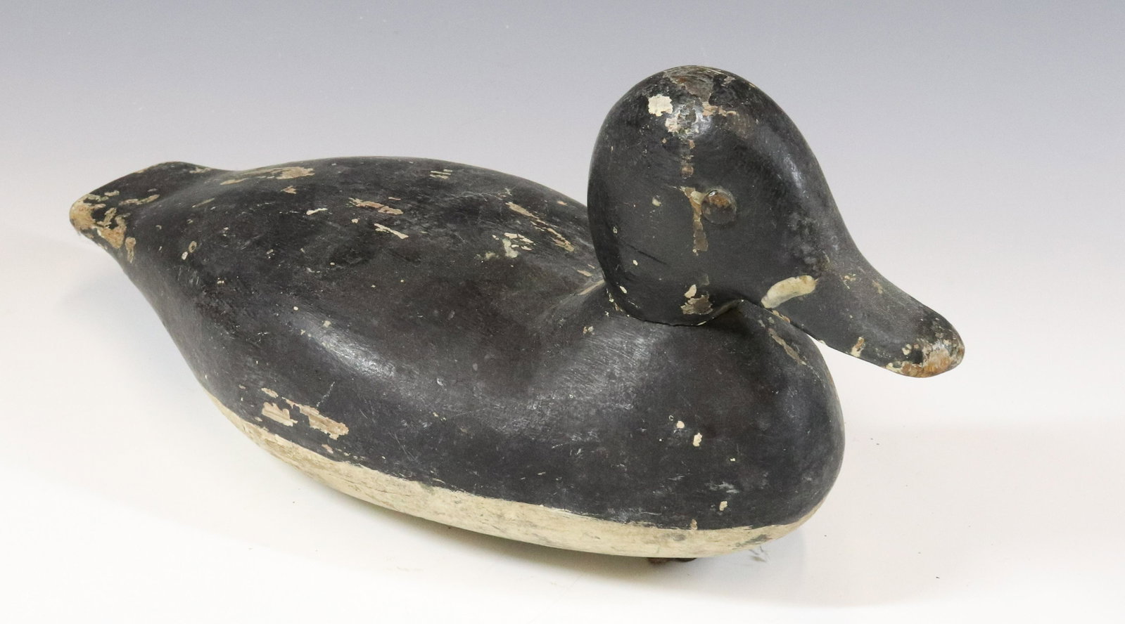 PAINTED WOODEN DECOY: BLACK//WHITE PAINTED SURFACE. PAINTED METAL EYES. WEIGHT AND HOOK ON BOTTOM. MEASURES 14" L. UPDATED 2023 Terms for Purchasing and Shipping of Auction Items. Please read carefully before bidding. All 