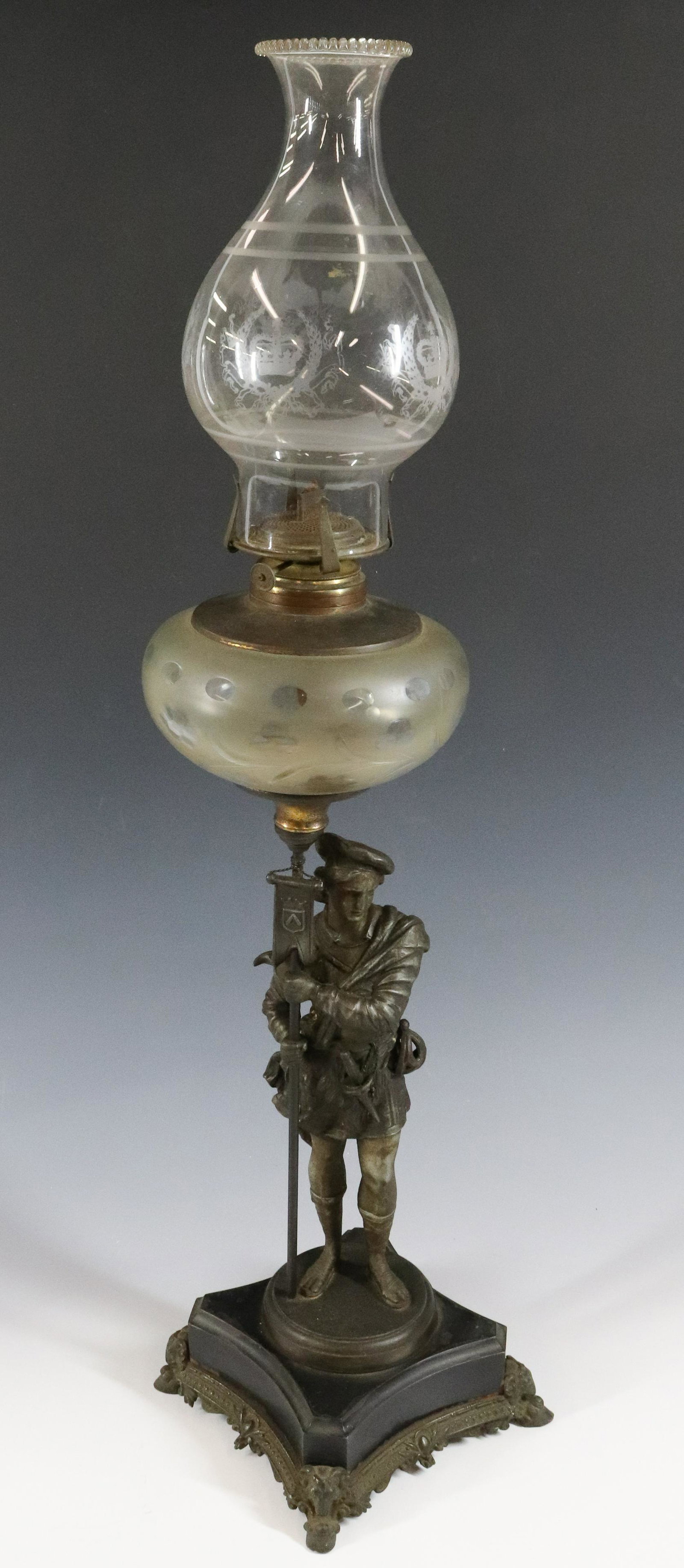 FIGURAL KEROSENE LAMP: SPELTER RENAISSANCE MAN WITH FLAG AND DAGGER. ETCHED CHIMNEY WITH CROWN AND WREATH. MEASURES 30 1/2" H. UPDATED 2023 Terms for Purchasing and Shipping of Auction Items. Please read carefully before bi
