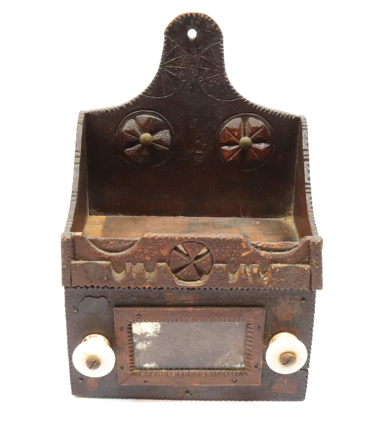 FOLK ART CARVED WALL BOX: SMALL SIZE HANGING WALL BOX WITH GEOMETRIC ETCHED DESIGNS AND CARVED PINWHEELS - CARVED FRONT DESIGN WITH PULL OUT DRAWER AND CARD HOLDER, PORCELAIN KNOBS - 9" X 6" X 5" PROVENANCE: UPDATED 2023 TERMS