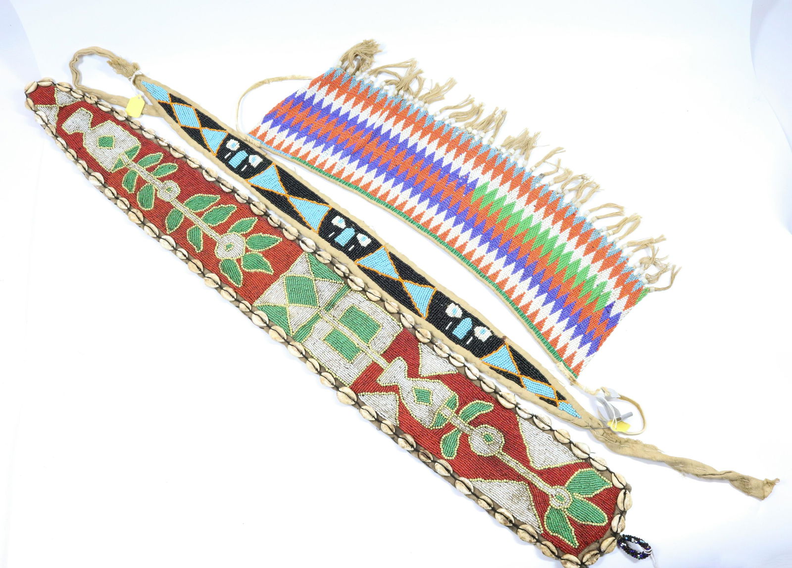 LOT OF AFRICAN BEADED BELTS: (3) INCLUDING - BLACK BEADED BELT TAGGED "YORUBA" - 21" TO 37" L PROVENANCE: UPDATED 2023 TERMS FOR PURCHASING AND SHIPPING OF AUCTION ITEMS. PLEASE READ CAREFULLY BEFORE BIDDING. ALL PAYMENTS FOR PUR