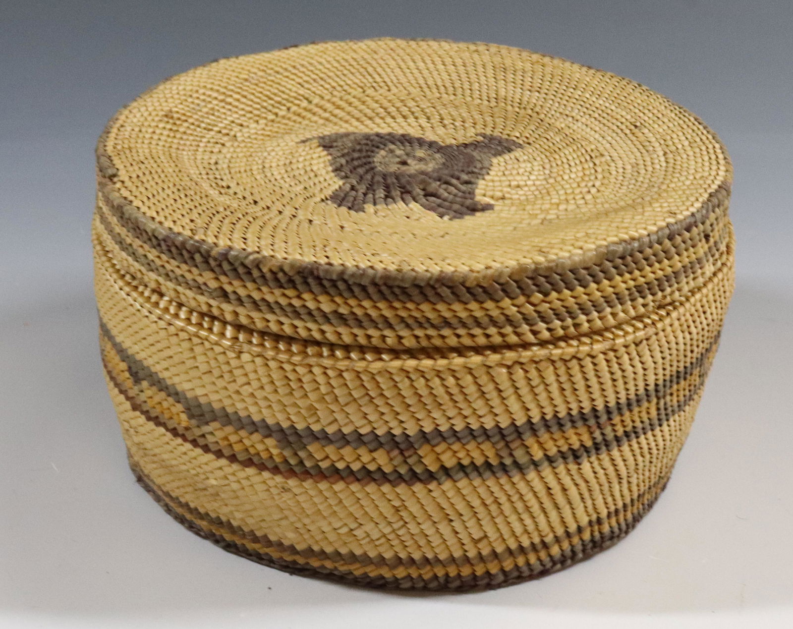 MAKAH LIDDED BASKET: 3" X 5 3/4". UPDATED 2023 TERMS FOR PURCHASING AND SHIPPING OF AUCTION ITEMS. PLEASE READ CAREFULLY BEFORE BIDDING. ALL PAYMENTS FOR PURCHASES WILL BE MADE THROUGH LIVEAUCTIONEERS.COM PAYMENT PROCESSI