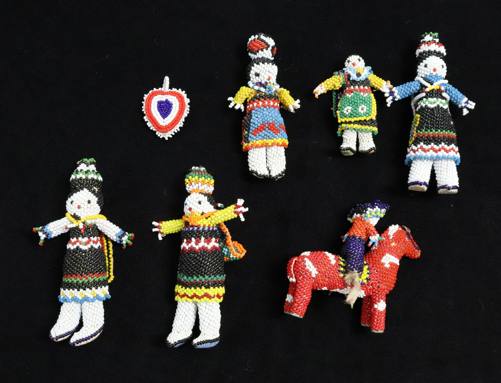LOT OF ZUNI BEADWORK FIGURES: SIX FIGURES, ONE ON HORSEBACK AND HEART PENDANT. LARGEST 5" H. UPDATED 2023 TERMS FOR PURCHASING AND SHIPPING OF AUCTION ITEMS. PLEASE READ CAREFULLY BEFORE BIDDING. ALL PAYMENTS FOR PURCHASES WILL BE