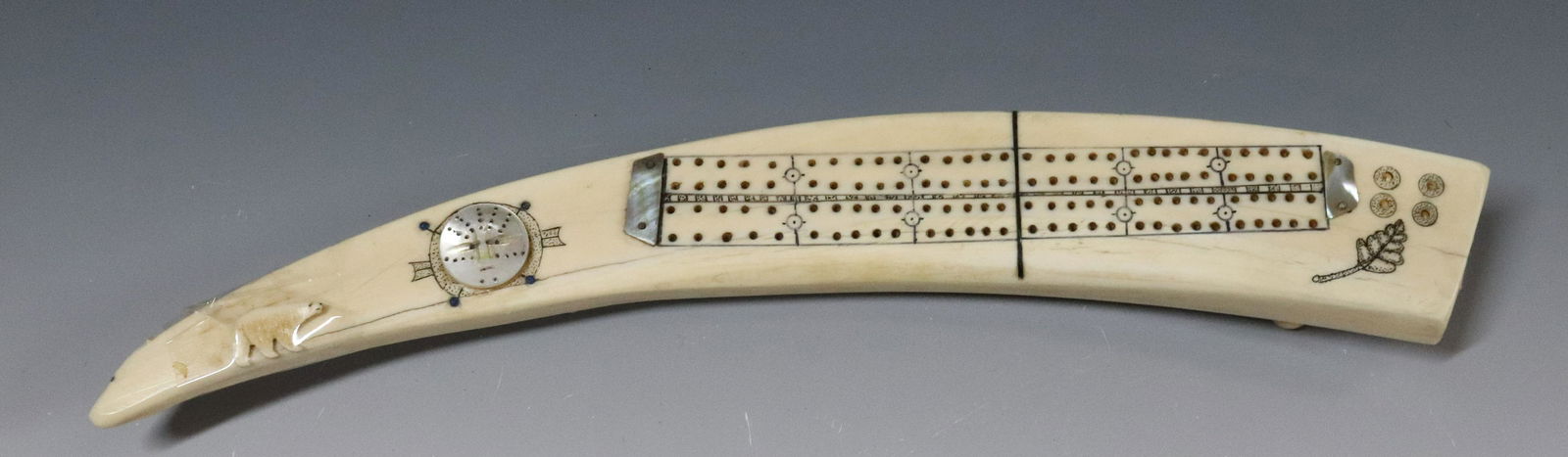 INUIT CARVED CRIBBAGE BOARD: CARVED BOARD WITH ABALONE ACCENTS - 14 1/2" L UPDATED 2023 TERMS FOR PURCHASING AND SHIPPING OF AUCTION ITEMS. PLEASE READ CAREFULLY BEFORE BIDDING. ALL PAYMENTS FOR PURCHASES WILL BE MADE THROUGH LIV