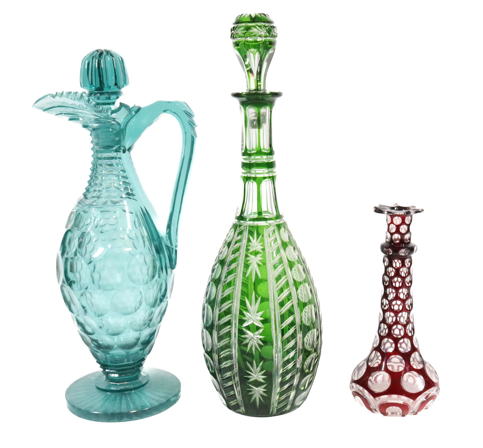 (3) OVERLAY AND CUT GLASS ITEMS: RUBY CUT TO CLEAR BOSTON & SANDWICH COLOGNE, EMERALD GREEN CUT TO CLEAR DECANTER AND GREEN CUT GLASS WINE EWER 7 1/2"H, 14 1/4"H,13 1/2'H Please Read Carefully before Bidding. Hartzell’s Auction