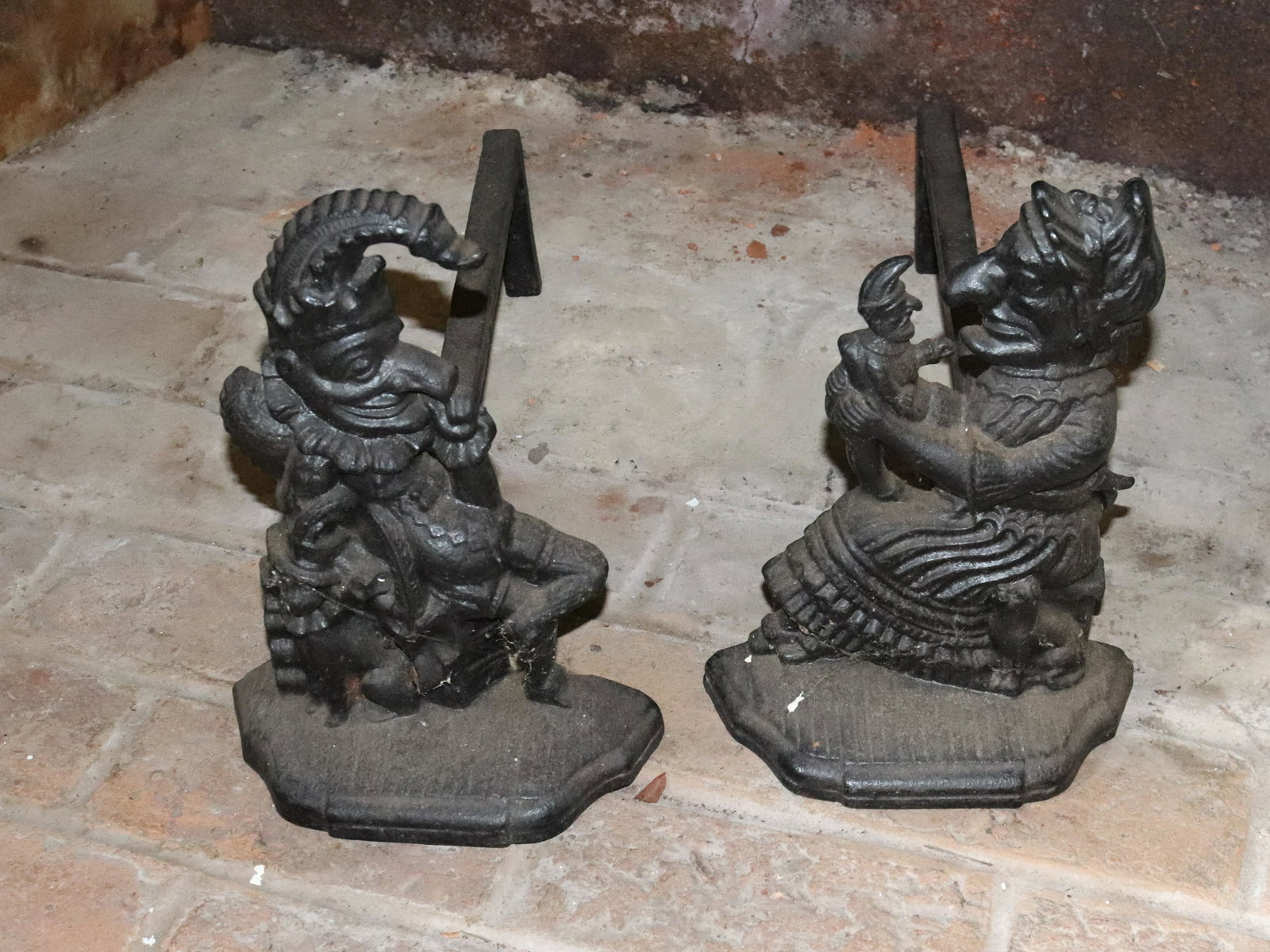 PUNCH AND JUDY ANDIRONS: BLACK PAINTED SURFACES. 12" X 9" X 21". Please Read Carefully before Bidding. Hartzell’s Auction Gallery Inc. will Conduct an ON-SITE and also ON-LINE Auction at 2481 Belvidere Rd, Phillipsburg,