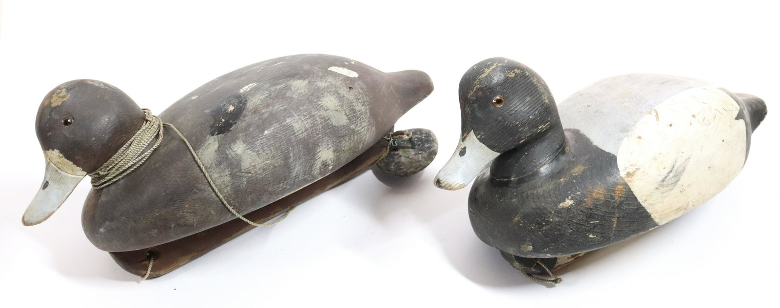 (2) R. KNIPE DUCK DECOYS: PAINTED WOODEN DECOYS WITH GLASS EYES, ONE HAS LINE AND LEAD WEIGHT - 14 1/2" L Please Read Carefully before Bidding. Hartzell’s Auction Gallery Inc. will Conduct an ON-SITE and also ON-LINE Auc