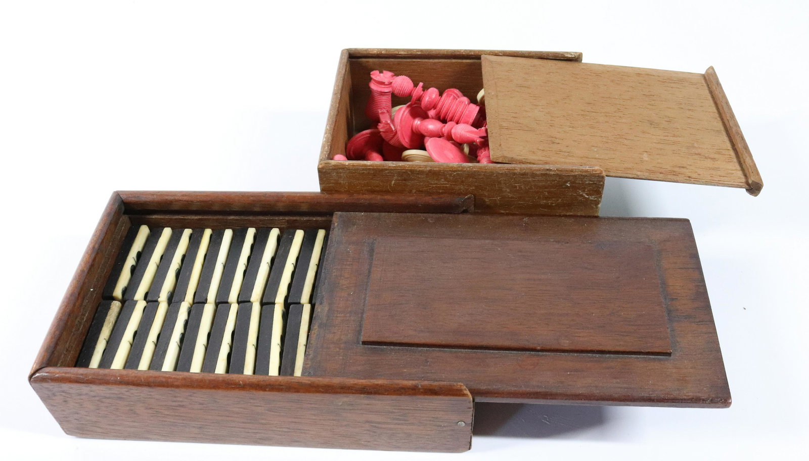 EARLY GAMING LOT: (2) SETS OF GAMING PIECES INCLUDING - SLIDE LID BOX CONTAINING EBONY AND BONE DOMINOES (28) AND SLIDE LID BOX WITH BONE CHESS PIECES Please Read Carefully before Bidding. Hartzellâ€™s Auction Gal