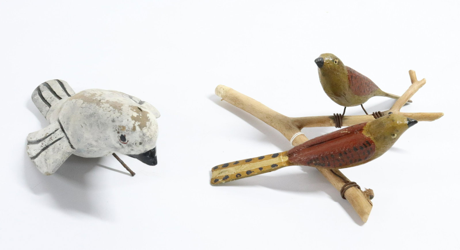 GROUP OF FOLK ART BIRDS: SINGLE WHITE AND BLACK PAINTED DOVE WITH NAIL IN BOTTOM AND PR. OF CARVED AND PAINTED BIRDS ON BRANCH -DOVE 9 1/2" - BIRDS 8" X 9" Please Read Carefully before Bidding. Hartzell’s Auction Galler