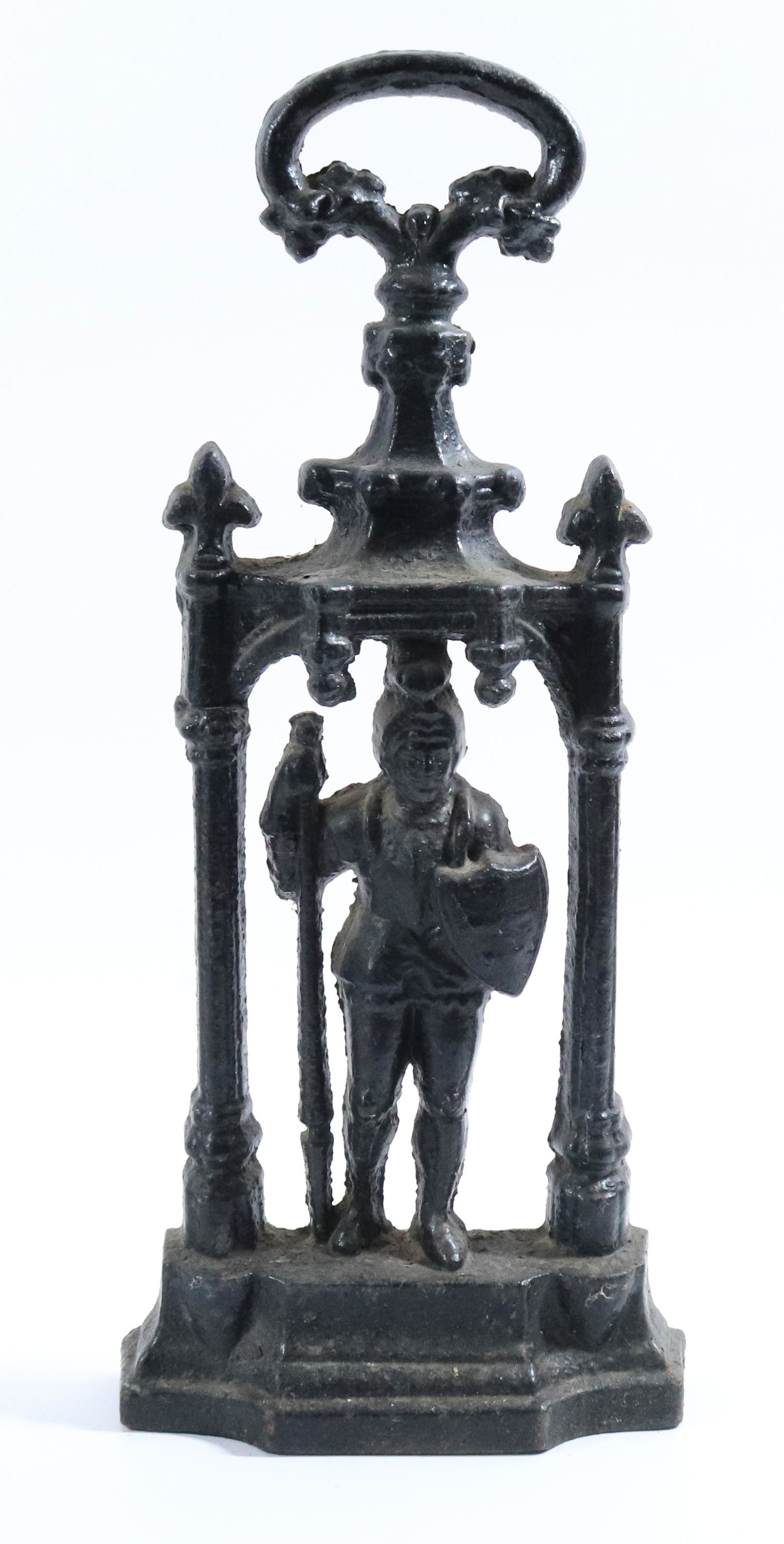 ORNATE CAST IRON DOORSTOP: DEPICTS MAN WITH SUIT OF ARMOR/SHIELD/SWORD. BLACK PAINTED SURFACE. 17 1/2" H. Please Read Carefully before Bidding. Hartzell’s Auction Gallery Inc. will Conduct an ON-SITE and also ON-LINE Auct