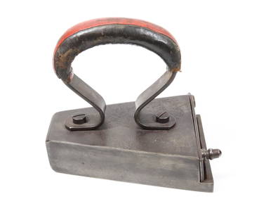 UNUSUAL GERMAN SLUG IRON: SQUARE TOE WITH REAR LIFT-GATE AND EXTENDED SOLE. LEATHER WRAPPED HANDLE. 5 1/2" L. Terms: PLEASE READ CAREFULLY BEFORE BIDDING. THIS IS AN ONLINE ONLY AUCTION. PREVIEWS WILL BE - WEDNESDAY