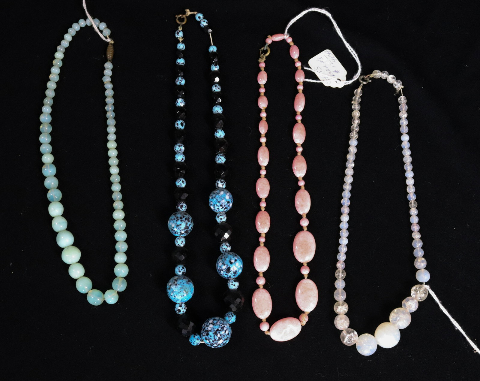 (4) CZECH GLASS BEADS: BLUE AND BLACK HAVE CUT FACETS, ALL GLASS 1930S 14" TO 16" Terms: Please Read Carefully before Bidding. Hartzell’s Auction Gallery Inc. will Conduct an ON-LINE ONLY Auction at 2481 Belvidere Rd, Phi