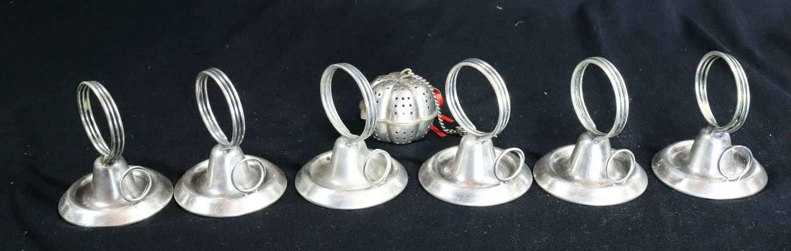 (7) SILVERPLATE MENU/PLACE CARD STANDS: CLIP FOR MENU AND PLACE CARD SHIP OR RESTAURANT 1930S AND NICKEL METAL TEA BALL 2 3/4"H Terms: Please Read Carefully before Bidding. Hartzell’s Auction Gallery Inc. will Conduct an ON-LINE ONLY Auct