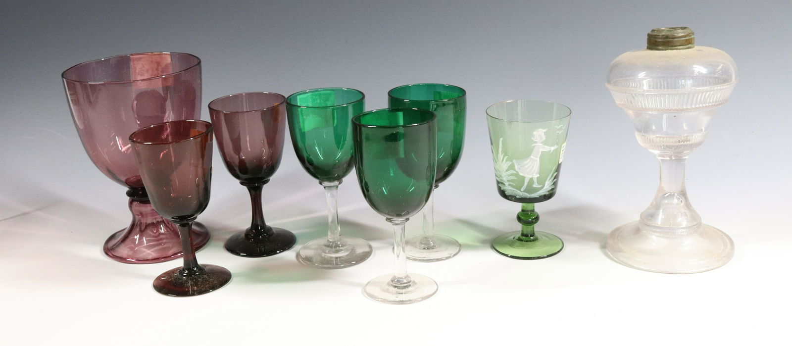 (8) BLOWN GLASS: STEUBEN AMETHYST VASE UNMARKED, THREE HAWK GREEN WINES, MARY GREGORY WINE, TWO AMETHYST AND PRESSED GLASS LAMP 4 1/2" TO 6" Terms: Please Read Carefully before Bidding. Hartzell’s Auction Gallery In