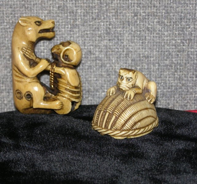 PR. CARVED IVORY NETSUKE - WOLF WITH SKELTON 2 1/: PR. CARVED IVORY NETSUKE - WOLF WITH SKELTON 2 1/4" & DEMON ON A BASKET WITH MAN UNDERNEATH 1 1/2"