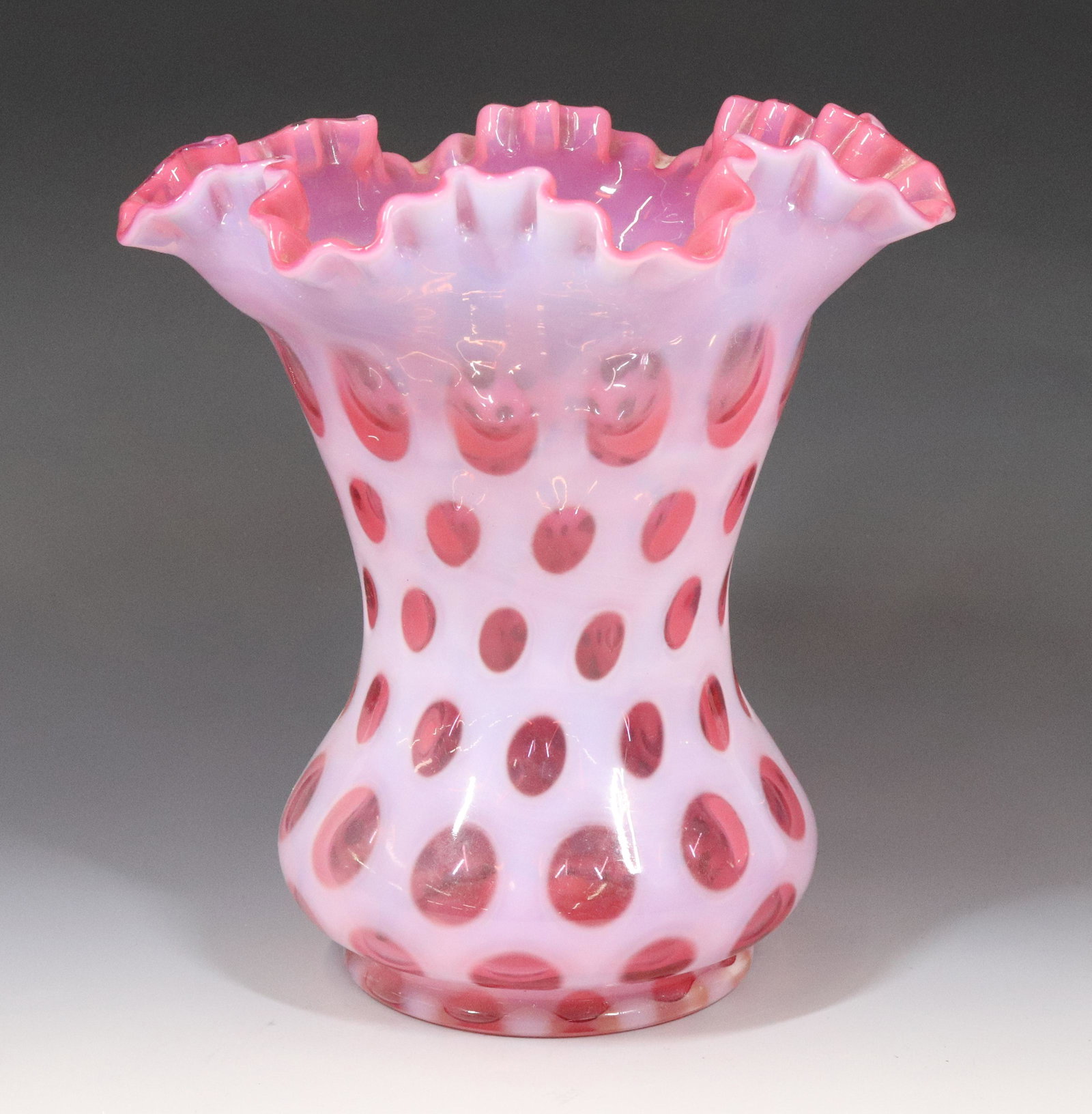 FENTON PINK COINSPOT VASE: RUFFLED RIM 8 1/2" X 8" TERMS: UPDATED 2023 TERMS FOR PURCHASING AND SHIPPING OF AUCTION ITEMS. PLEASE READ CAREFULLY BEFORE BIDDING. ALL PAYMENTS FOR PURCHASES WILL BE MADE THROUGH LIVEAUCTIONEERS.CO
