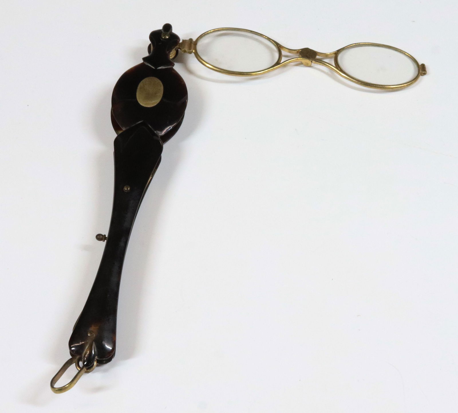 HAND HELD EYE GLASS: GOLD FILLED AND TURTLE SHELL WORKING MECHANISM 1880 6 1/2" X 5" TERMS: UPDATED 2023 TERMS FOR PURCHASING AND SHIPPING OF AUCTION ITEMS. PLEASE READ CAREFULLY BEFORE BIDDING. ALL PAYMENTS FOR PURCHASES