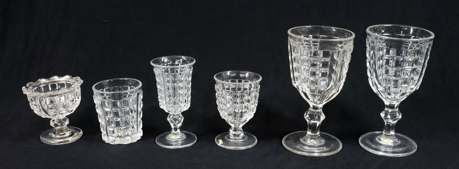 BOSTON & SANDWICH FLINT GLASS: (6) WAFFLE PATTERN TWO GOBLETS, CHAMPAGNE, EGG CUP, MASTER SALT AND ONE TUMBLER POLISHED PONTILS 3 1/4" TO 6 1/4"H TERMS: UPDATED 2023 TERMS FOR PURCHASING AND SHIPPING OF AUCTION ITEMS. PLEASE READ C