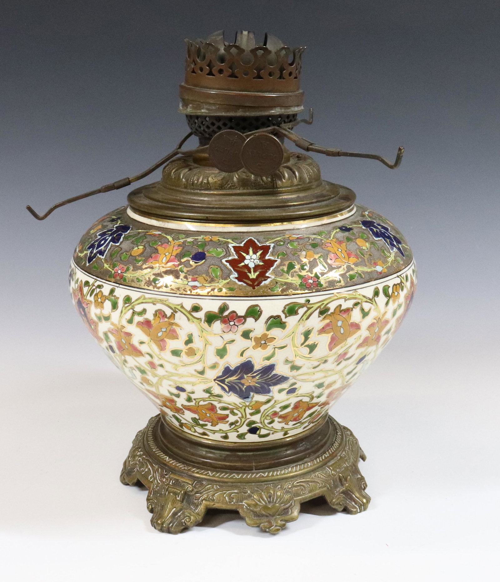 CERAMIC KEROSENE LAMP: HUNGARIAN CERAMIC WITH DROP IN FONT AND BURNER BRASS BASE MARKED J.W. 11 1/2" X 8 1/2" TERMS: UPDATED 2023 TERMS FOR PURCHASING AND SHIPPING OF AUCTION ITEMS. PLEASE READ CAREFULLY BEFORE BIDDING. ALL