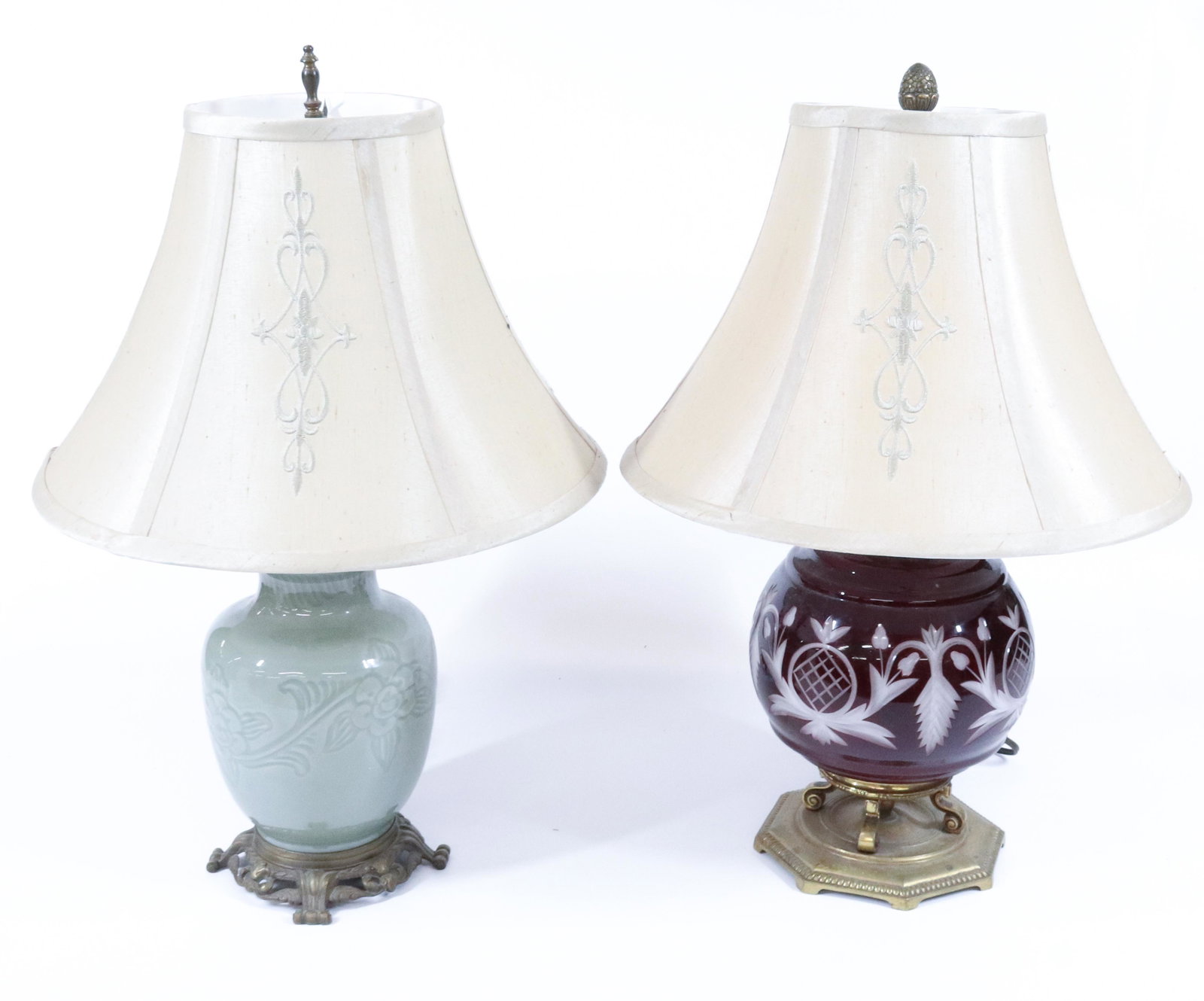 (2) VINTAGE DECORATIVE LAMPS: GREEN CELADON-STYLE WITH FLORAL DECORATION AND RED GLASS WITH CUT FLORAL DECORATION. MATCHING SHADES. BOTH 21" H. TERMS: UPDATED 2023 TERMS FOR PURCHASING AND SHIPPING OF AUCTION ITEMS. PLEASE READ CA