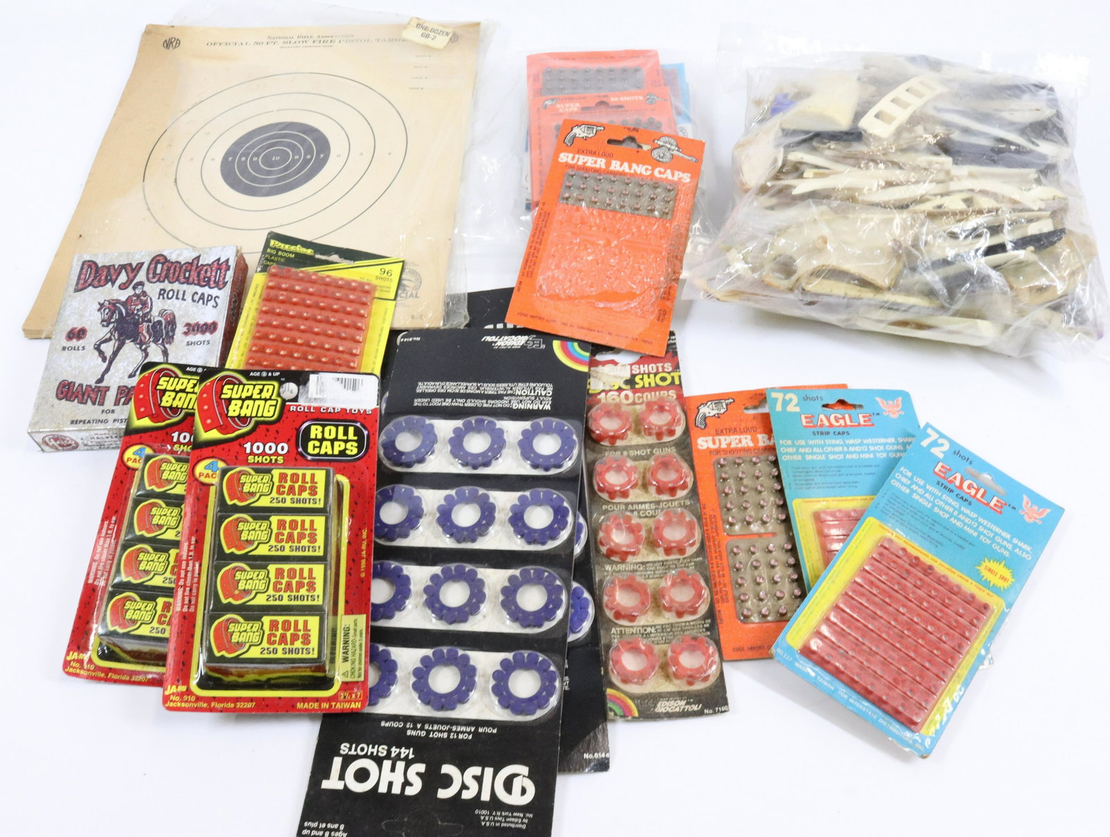 LOT OF PLASTIC CAPS AND TOY GUN GRIPS: VARIOUS STYLES AND SIZES.