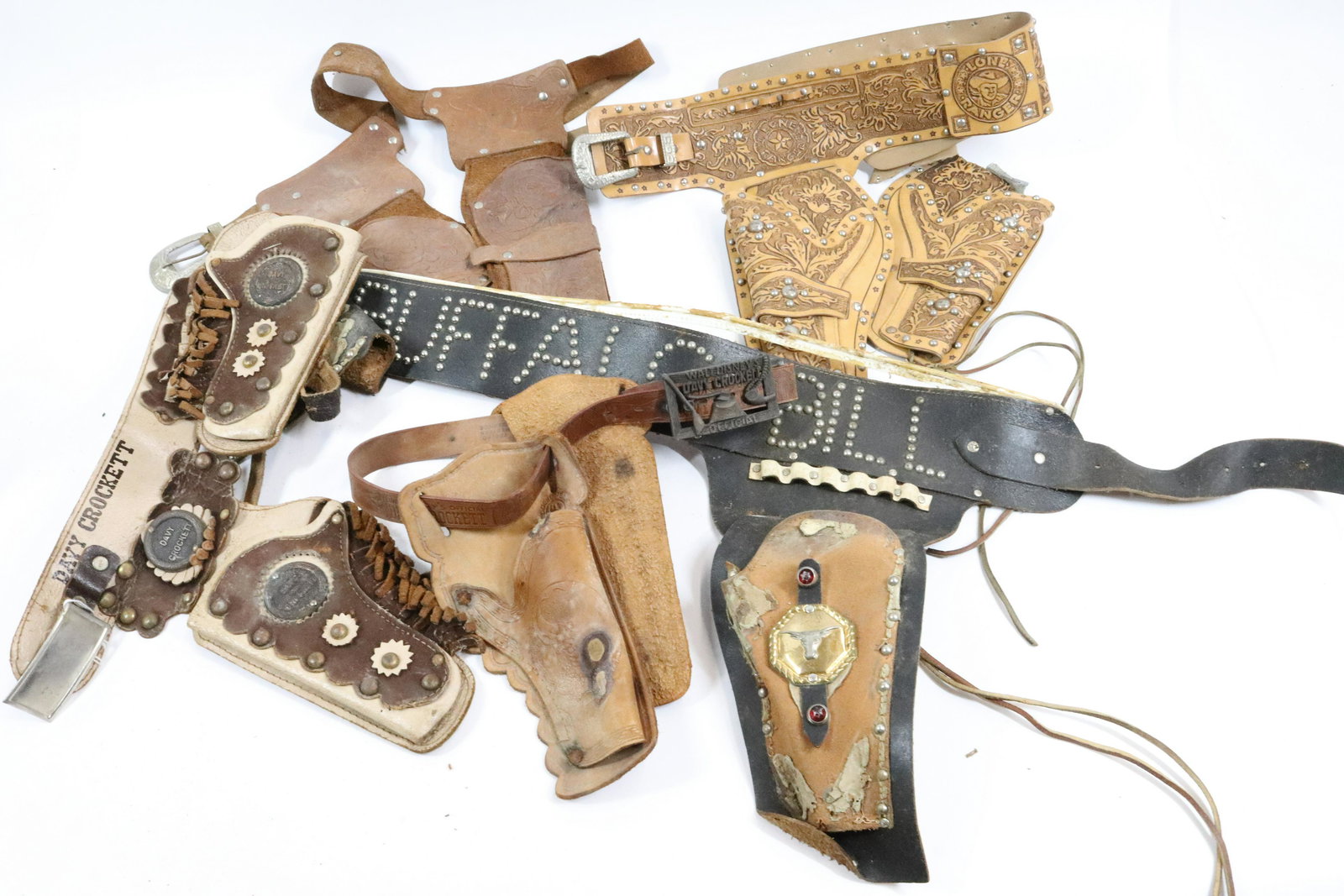 LOT OF TOY CAP GUN HOLSTERS: VARIOUS STYLES INCLUDING: DAVY CROCKETT, WALT DISNEY'S OFFICIAL DAVY CROCKETT, BUFFALO BILL, BONANZA AND LONE RANGER.