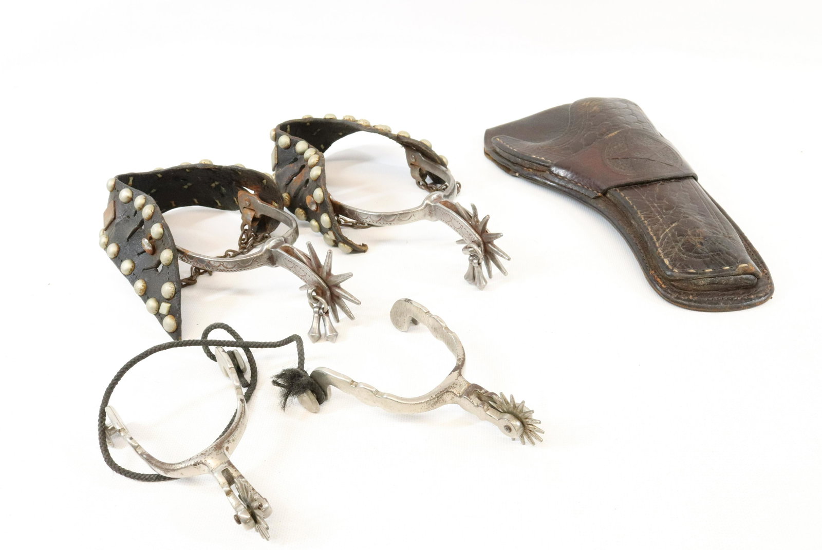 SPURS AND HOLSTER LOT: J.P. WROE LEATHER HOLSTER STAMPED "RANGER" ON REVERSE - LEATHER AND METAL SPURS WITH APPLIED METAL DESIGN, SPURS WITH HEART MOTIF Terms: UPDATED 2023 TERMS FOR PURCHASING AND SHIPPING OF AUCTION ITEMS
