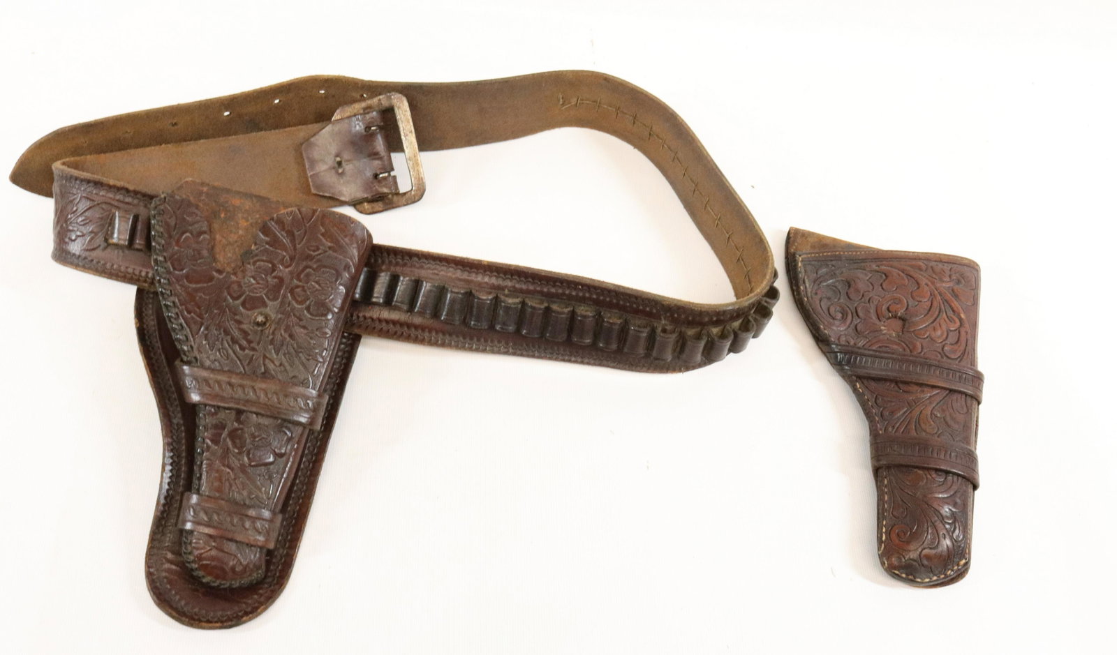 HAND TOOLED LEATHER BELT AND HOLSTER: FOR A COLT LIGHTNING - (2) HOLSTERS AND BELT 43" Terms: UPDATED 2023 TERMS FOR PURCHASING AND SHIPPING OF AUCTION ITEMS. PLEASE READ CAREFULLY BEFORE BIDDING. ALL PAYMENTS MUST BE MADE BEFORE ITEMS CA