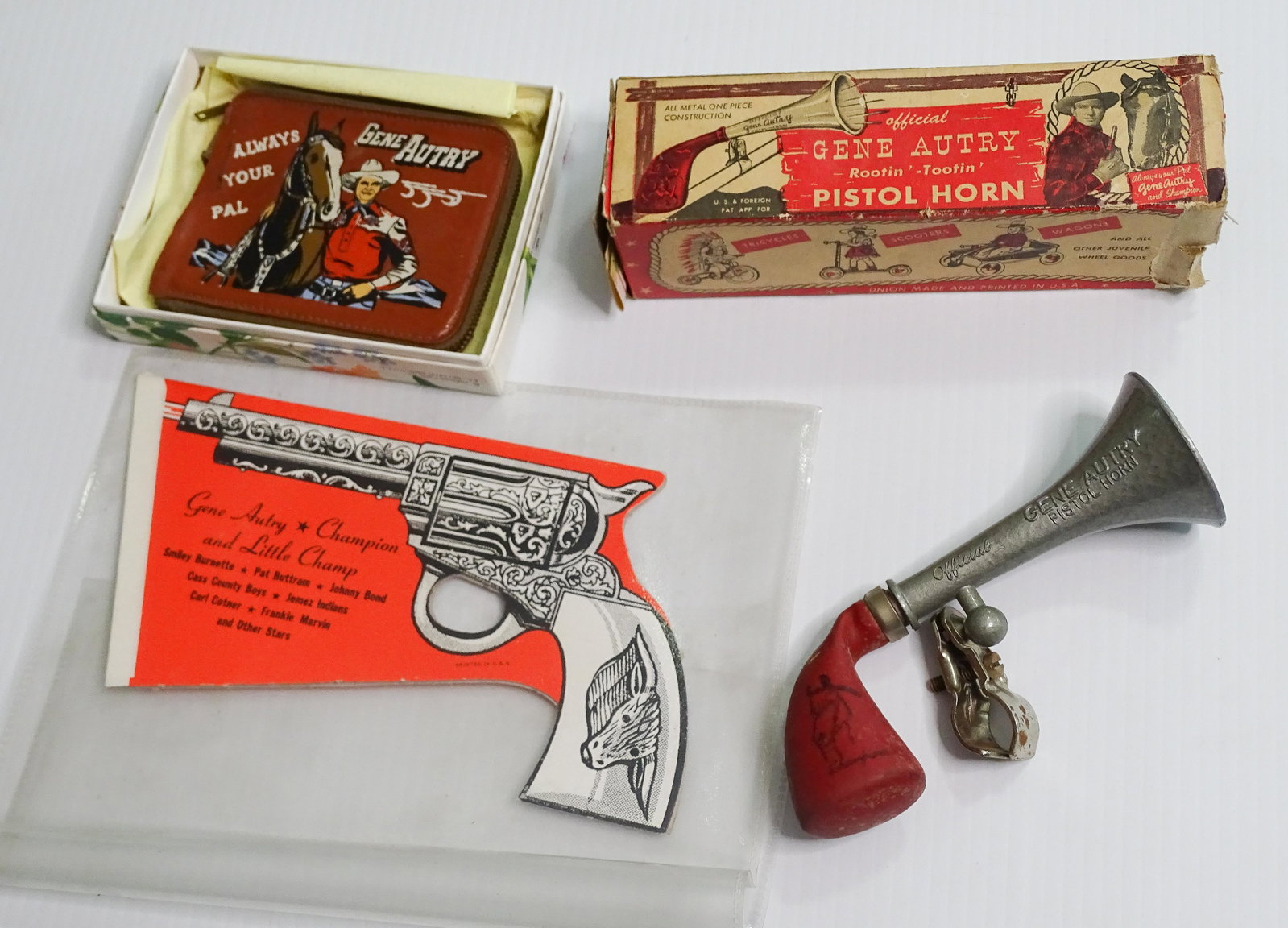 (3) GENE AUTRY ITEMS: PISTOL HORN IN BOX WALLET AND FIGURAL SHOW PLACARD UPDATED 2023 Terms for Purchasing and Shipping of Auction Items. Please read carefully before bidding. All payments for purchases will be made throug
