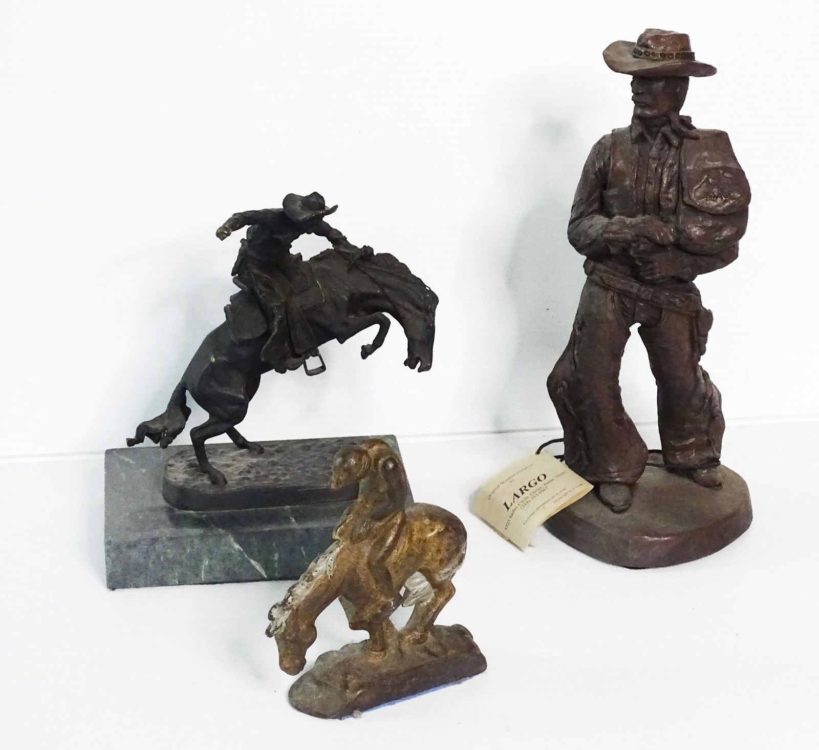 (3) VINTAGE WESTERN THEME FIGURINES: PLASTER COWBOY BY LARGO, REMINGTON BRASS COPY MOUNTED ON MARBLE AND CAST IRON BOOKEND 6" TO 12 1/2" UPDATED 2023 Terms for Purchasing and Shipping of Auction Items. Please read carefully before biddin
