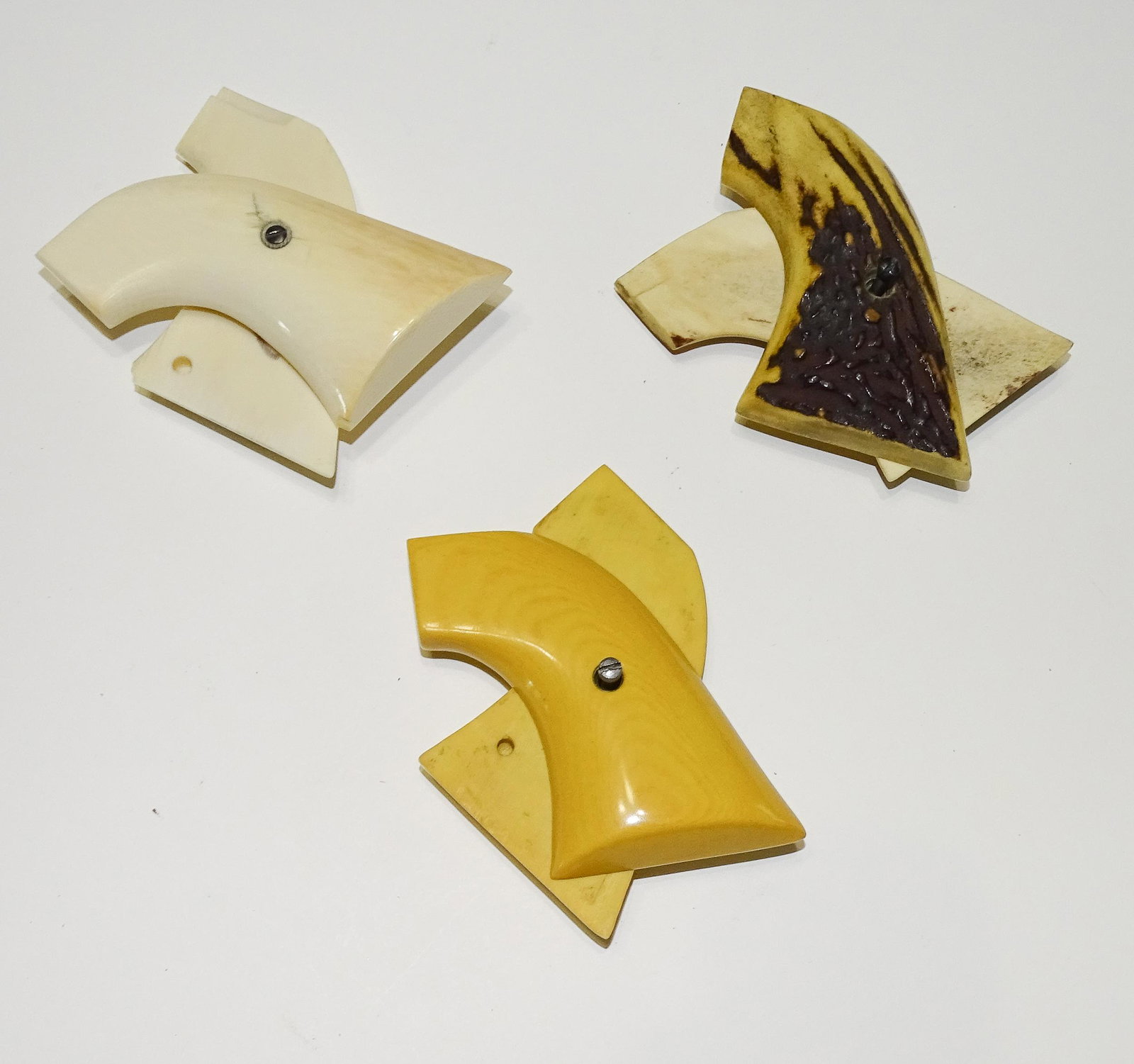(3) PAIR REVOLVER GRIPS: NATURAL HORN, BONE AND FAUX IVORY 3" UPDATED 2023 Terms for Purchasing and Shipping of Auction Items. Please read carefully before bidding. All payments for purchases will be made through LiveAuctione