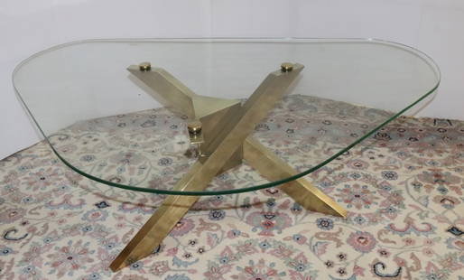 1970'S GEOMETRIC BRASS TRIPODAL COFFEE TABLE: PATINATED BRASS COFFEE TABLE WITH WITH MITERED LEGS AND ELONGATED TRIANGULAR CENTER - CAPS SECURE GLASS TOPS TO BASE, 15 1/2" X 50" X 33 1/2" PLEASE READ CAREFULLY - Terms for Purchasing and Shipping