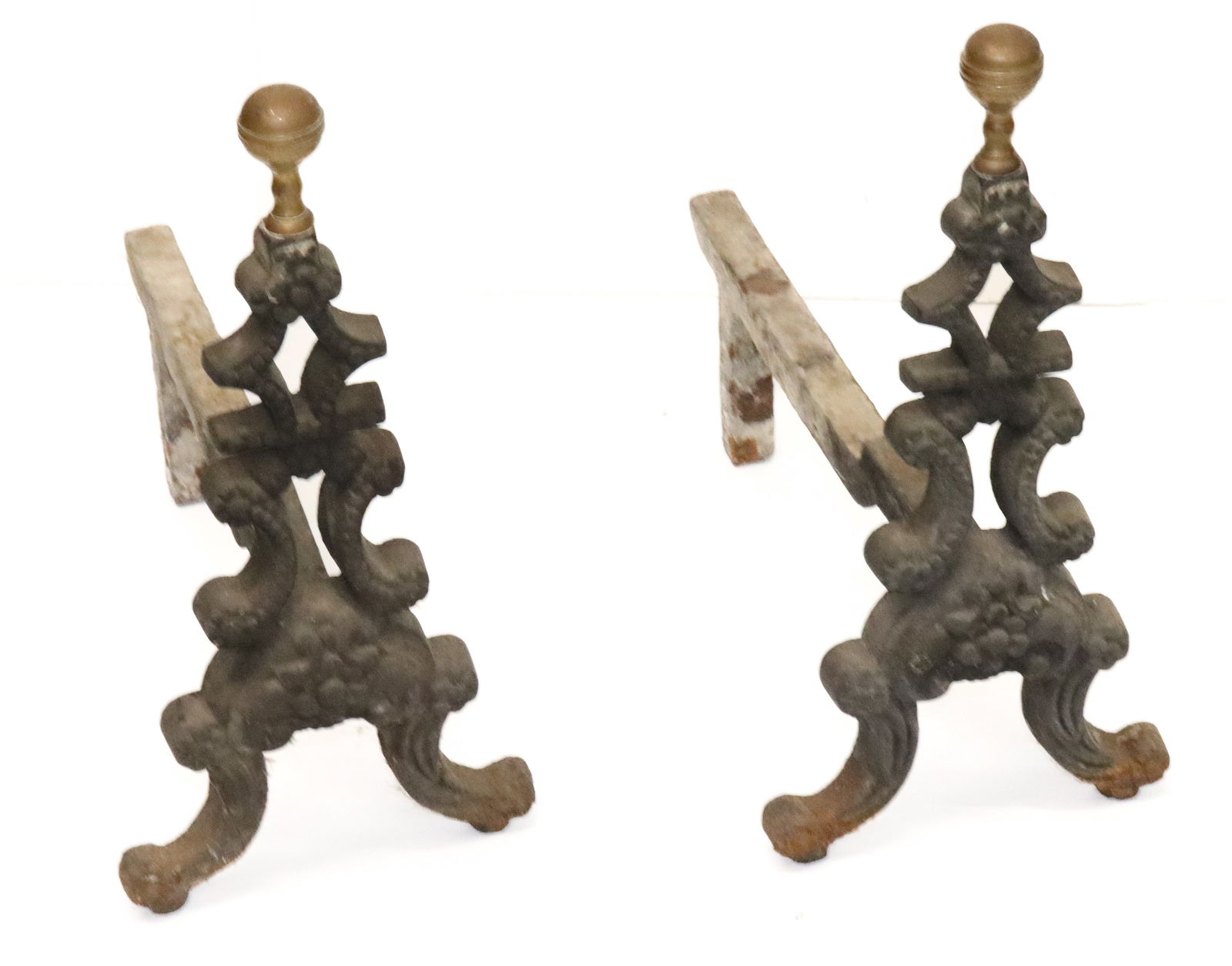 PAIR OF CAST IRON ANDIRONS: FLORAL PATTERN WITH BRASS FINIALS. 14 1/2" H. X 15" D. PLEASE READ CAREFULLY - Terms for Purchasing and Shipping of Auction Items. Please read carefully before bidding. All payments for purchases will